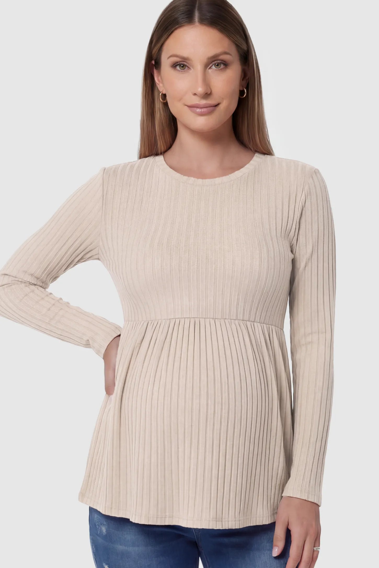 Ribbed Knit Long Sleeve Maternity Top Ribbed Knit Long Sleeve Maternity Top in Beige featuring an empire waist and high-stretch fabric on a pregnant model.