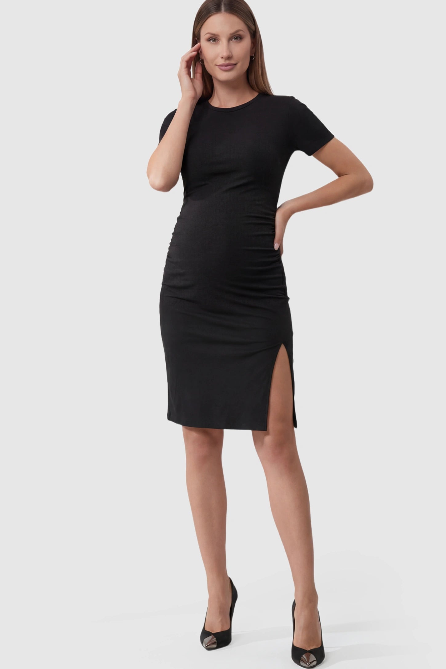 Side-Slit Ruched Bodycon Maternity Short Dress in Black featuring a sleek side slit and side ruching on a pregnant model.