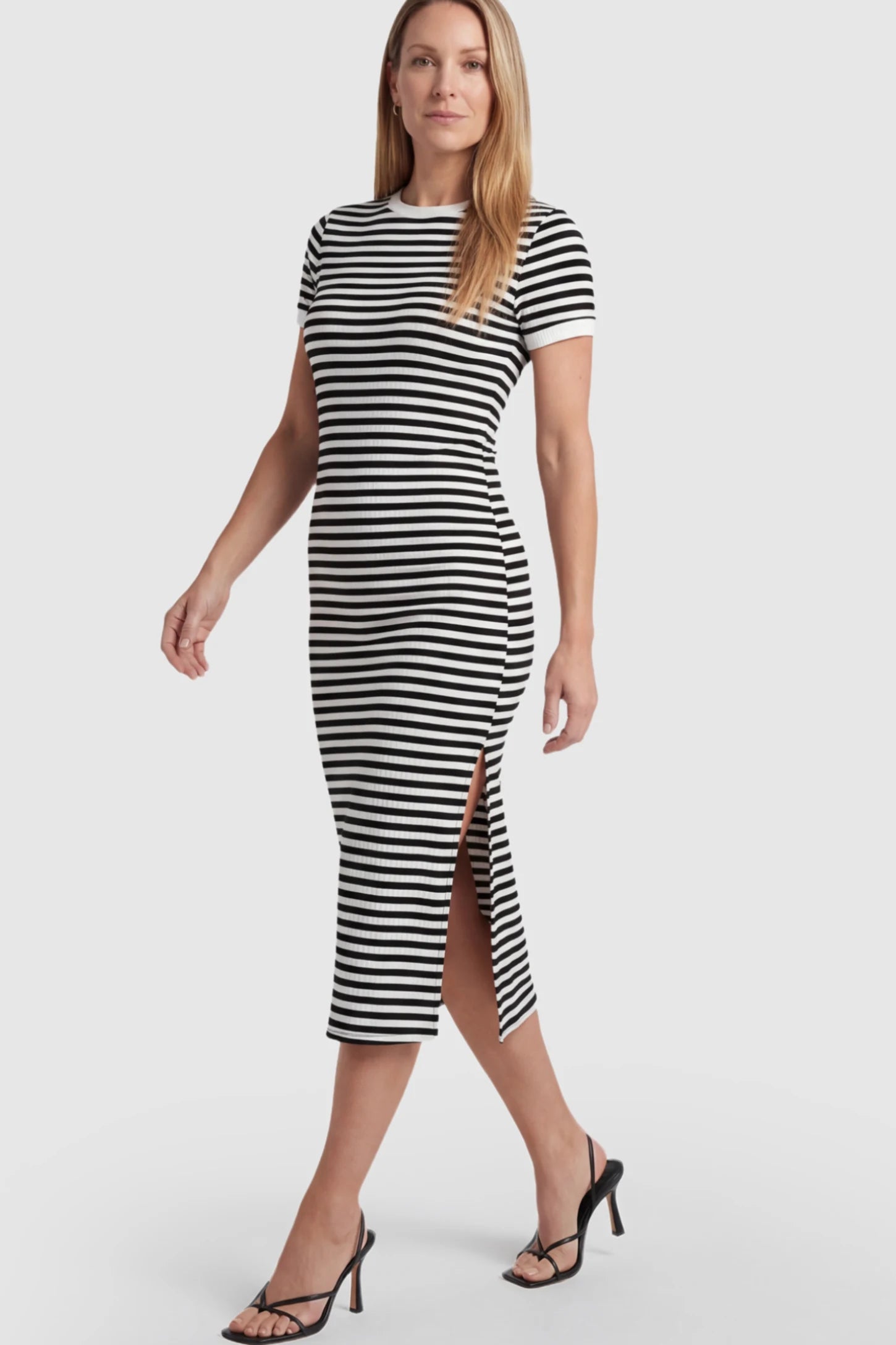 Striped Side-Slit Bodycon Maternity Midi Dress Striped Side-Slit Bodycon Maternity Midi Dress in Black and White featuring a side slit on a postpartum model.