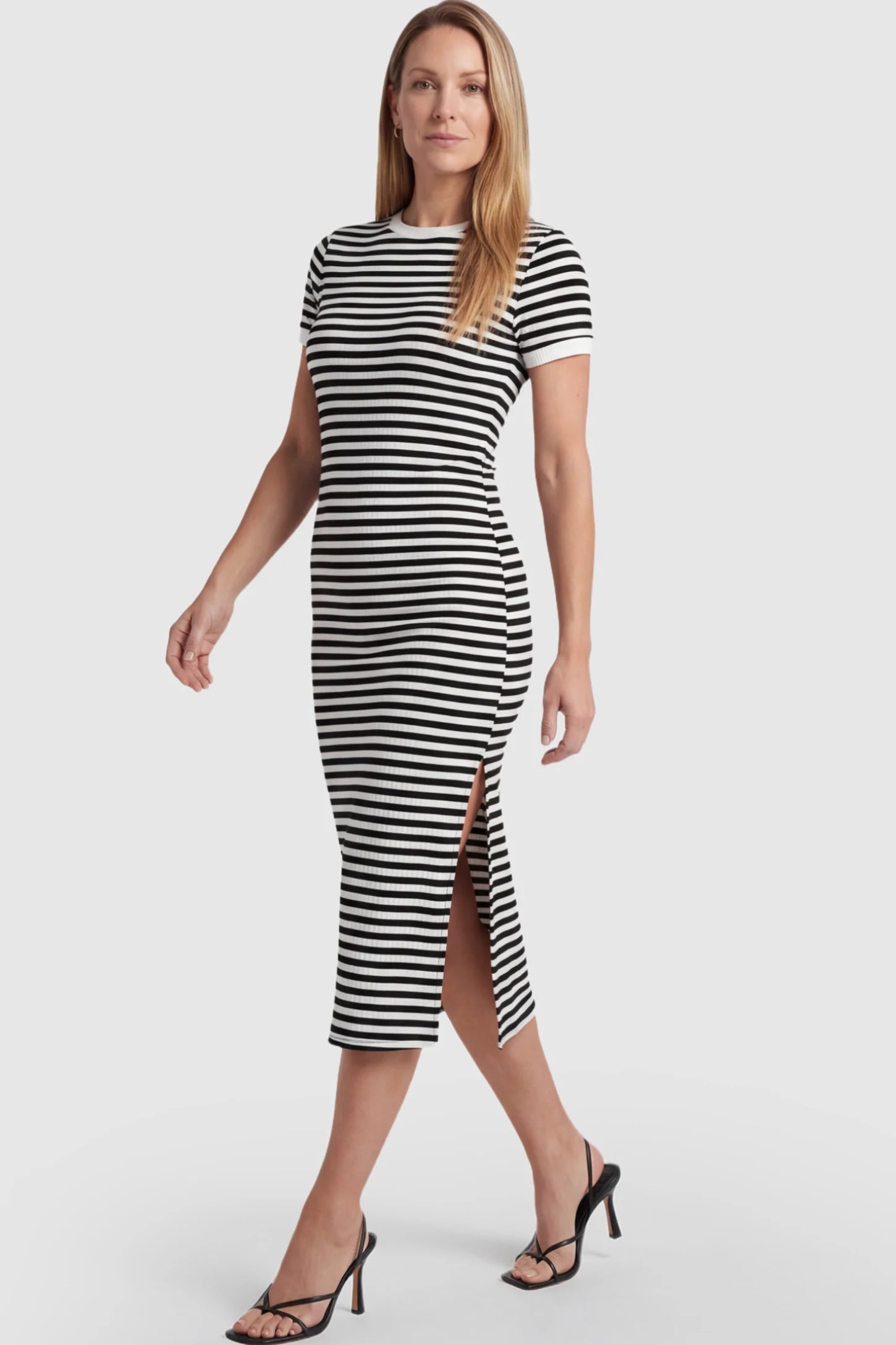 Striped Side-Slit Bodycon Maternity Midi Dress Striped Side-Slit Bodycon Maternity Midi Dress in Black and White featuring a side slit on a pregnant model.