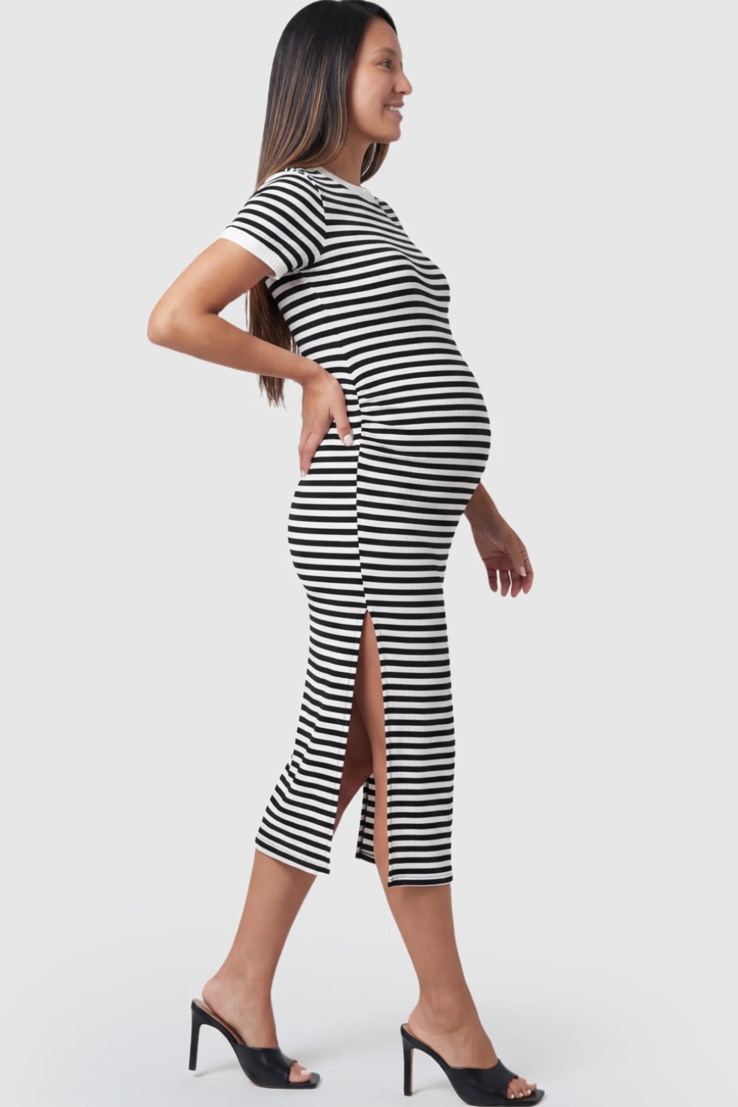 Striped Side-Slit Bodycon Maternity Midi Dress Striped Side-Slit Bodycon Maternity Midi Dress in Black and White featuring a side slit on a pregnant model.