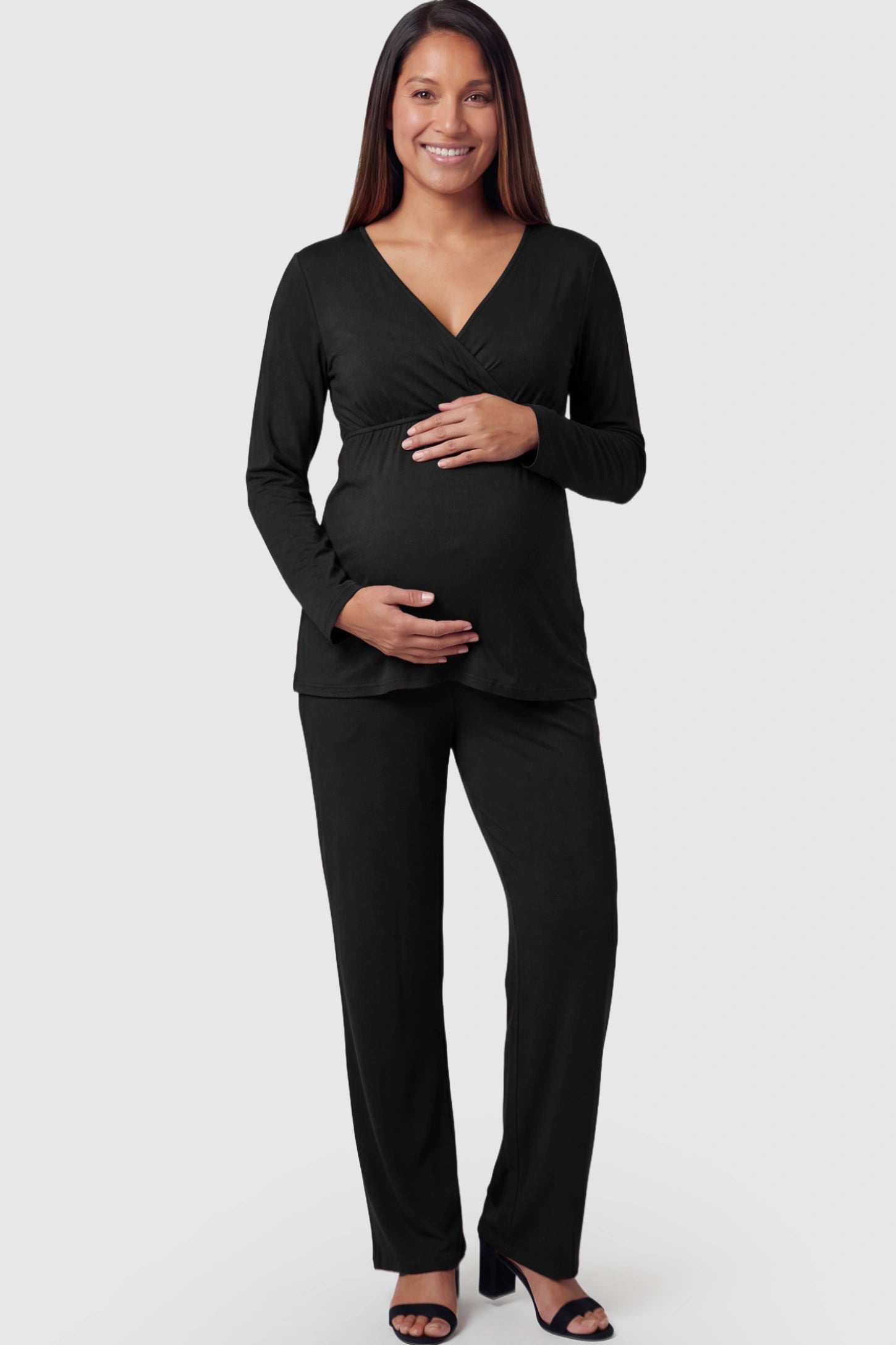 V-Neck Long Sleeve Top with Long Pants Maternity Lounge Set V-Neck Long Sleeve Maternity Lounge Set in Black featuring a crossover front on a pregnant model.