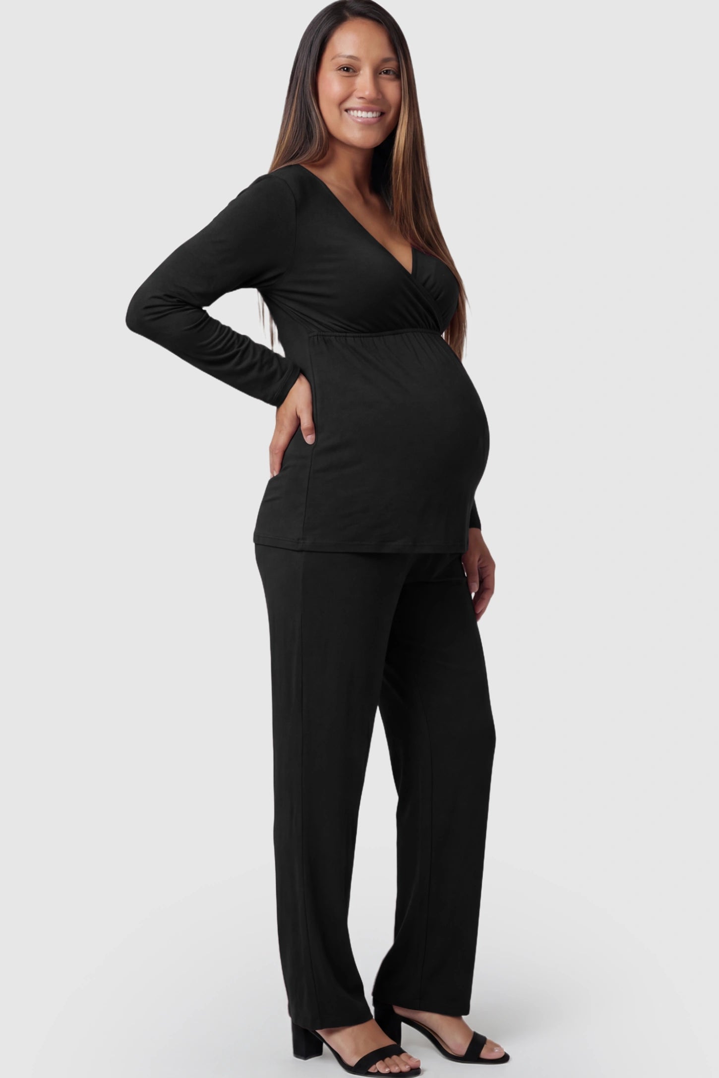 V-Neck Long Sleeve Top with Long Pants Maternity Lounge Set V-Neck Long Sleeve Maternity Lounge Set in Black featuring a crossover front on a pregnant model.