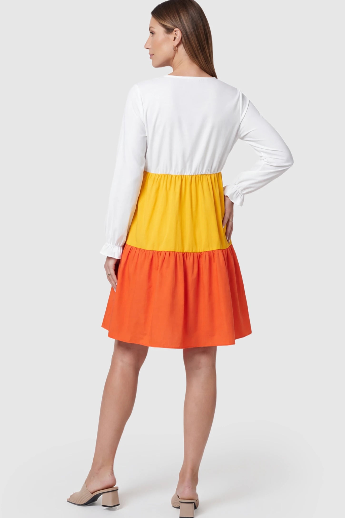 Ruffle V-Neck Colorblock Tiered Maternity Nursing Dress Ruffle V-Neck Colorblock Tiered Maternity Nursing Dress in White, Yellow, and Orange on a pregnant model.