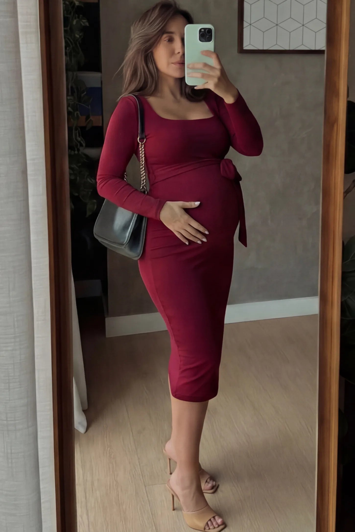 Square Neck Side-Tie Maternity Midi Dress Square Neck Side-Tie Maternity Midi Dress in Burgundy featuring a long-sleeve bodycon fit on a pregnant model.