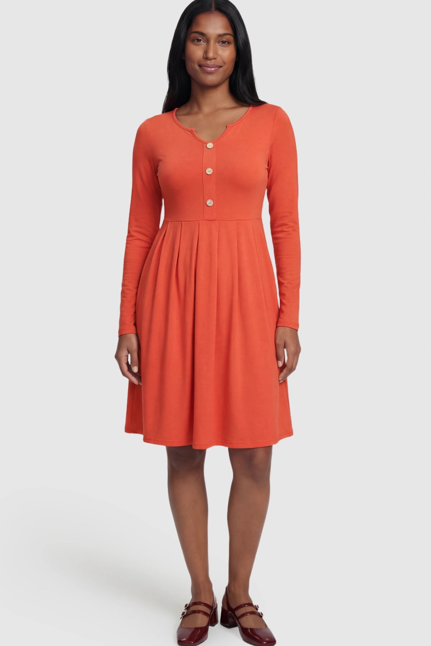 Button Accent Empire Waist Maternity Short Dress Button Accent Pleated Empire Waist Maternity Short Dress in Orange featuring a high-set waist on a postpartum model.
