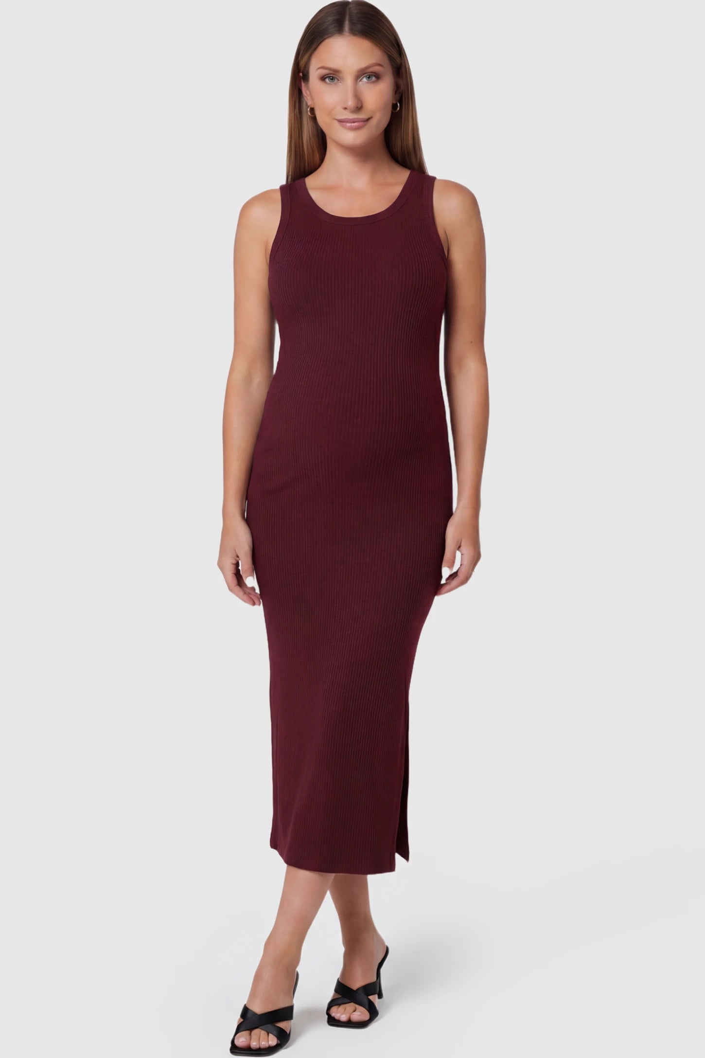Ribbed Knit Sleeveless Maternity Midi Dress in Burgundy featuring a side slit and crew neck on a pregnant model.