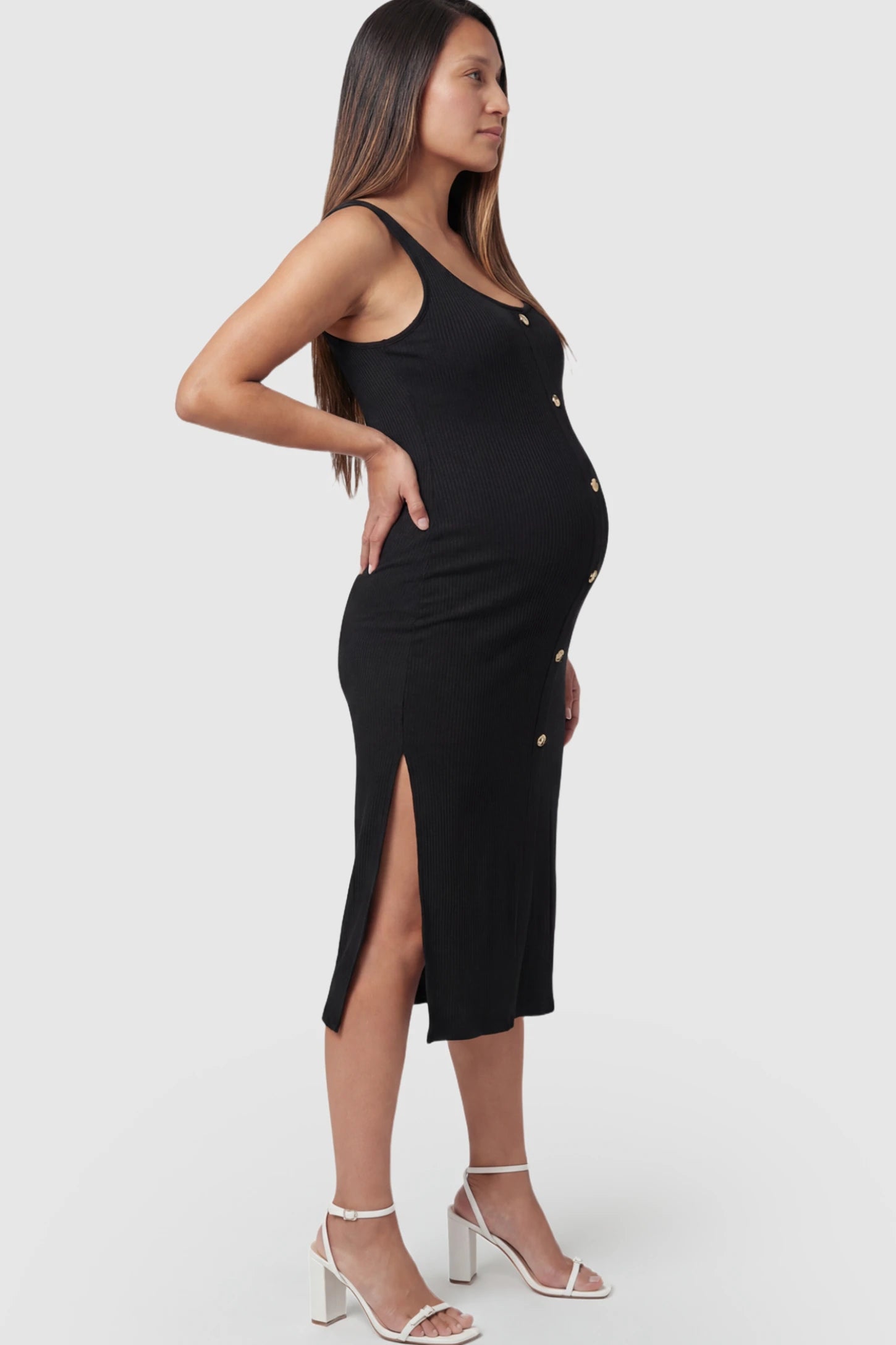 Ribbed Button Accent Side Slit Maternity Midi Dress Ribbed Button Accent Side Slit Maternity Midi Dress in Black featuring a flexible knit and decorative buttons on a pregnant model.