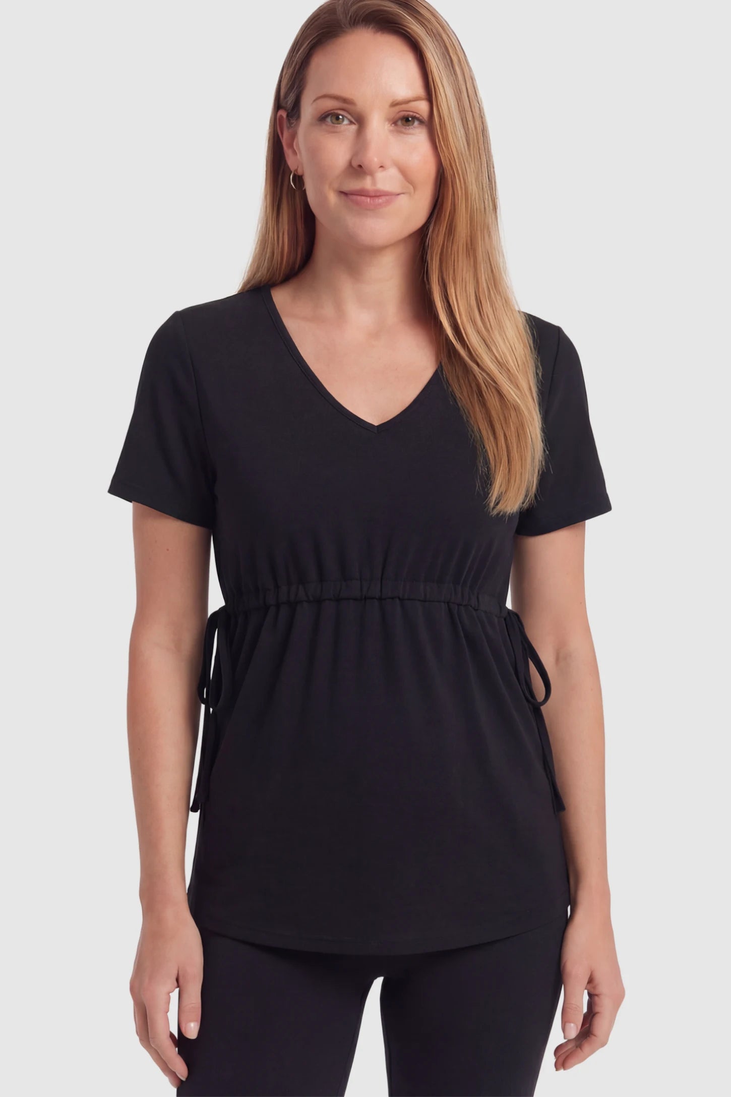 Cinched Waist Short Sleeve Maternity Tunic Top Cinched Waist Short Sleeve Maternity Tunic in Black with an adjustable drawstring waist on a postpartum model in front view.