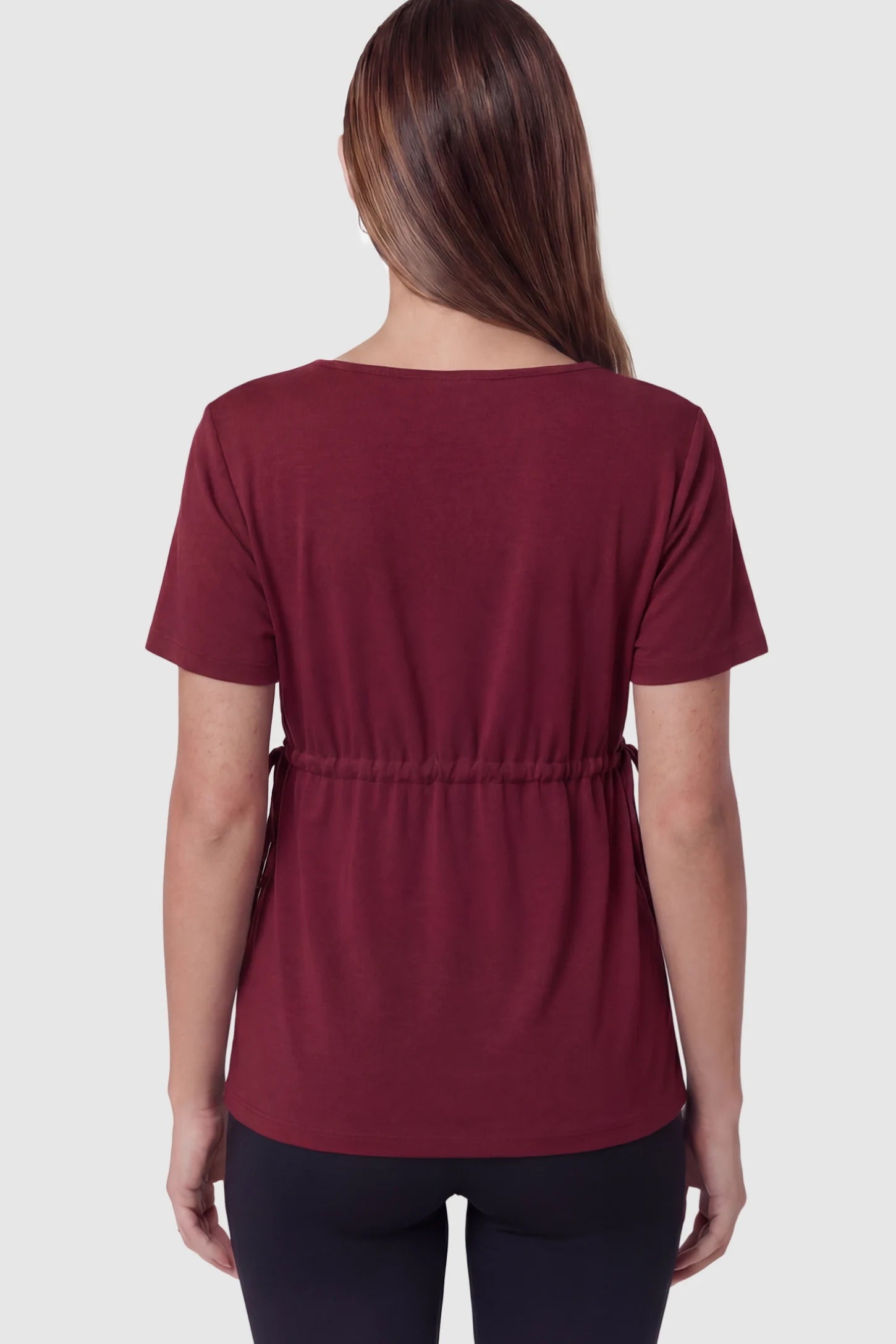 Cinched Waist Short Sleeve Maternity Tunic Top Cinched Waist Short Sleeve Maternity Tunic in Burgundy featuring a empire waist on a pregnant model in back view.