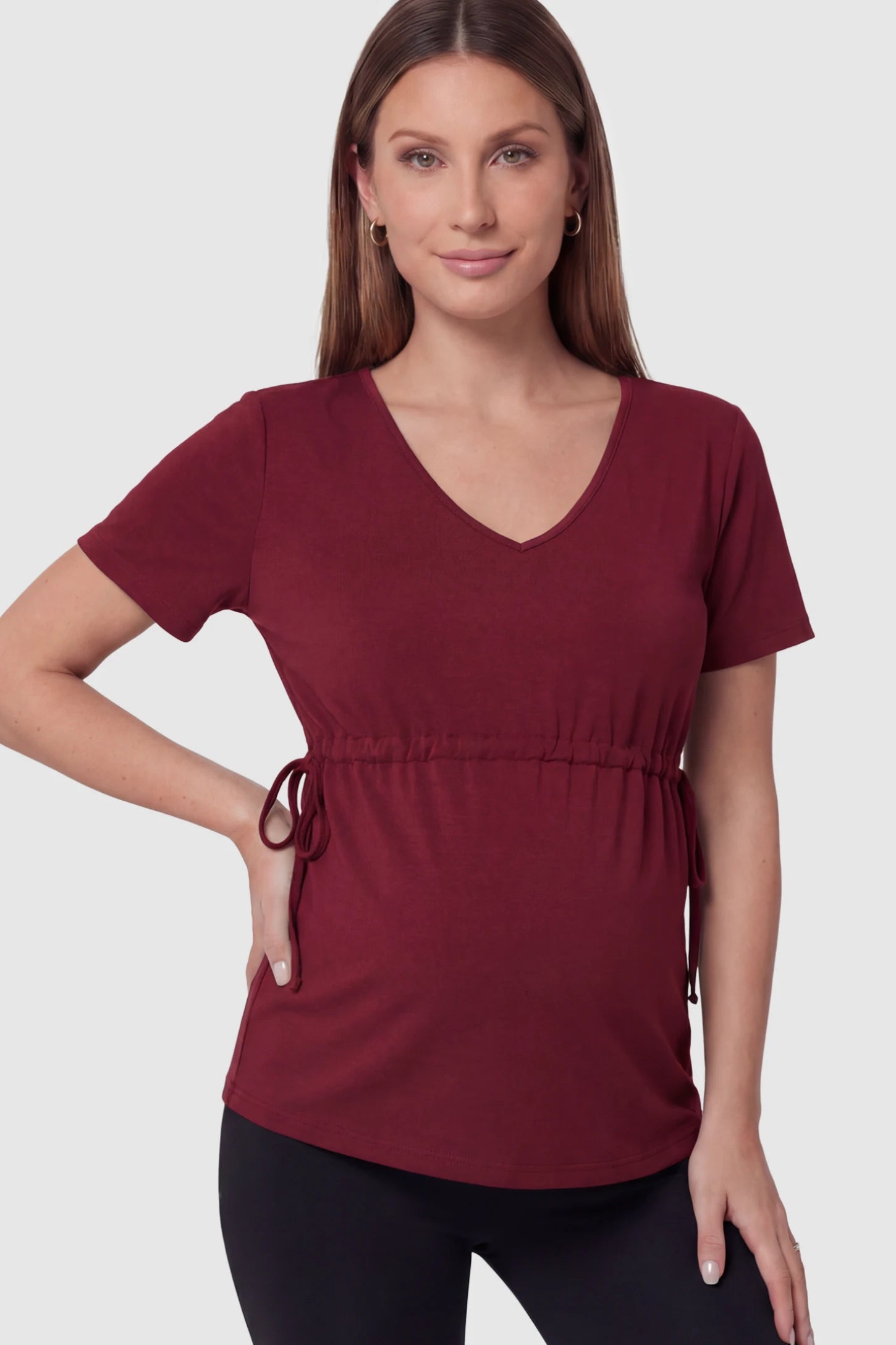 Cinched Waist Short Sleeve Maternity Tunic Top Cinched Waist Short Sleeve Maternity Tunic in Burgundy featuring a stretchy drawstring waist on a pregnant model in front view.