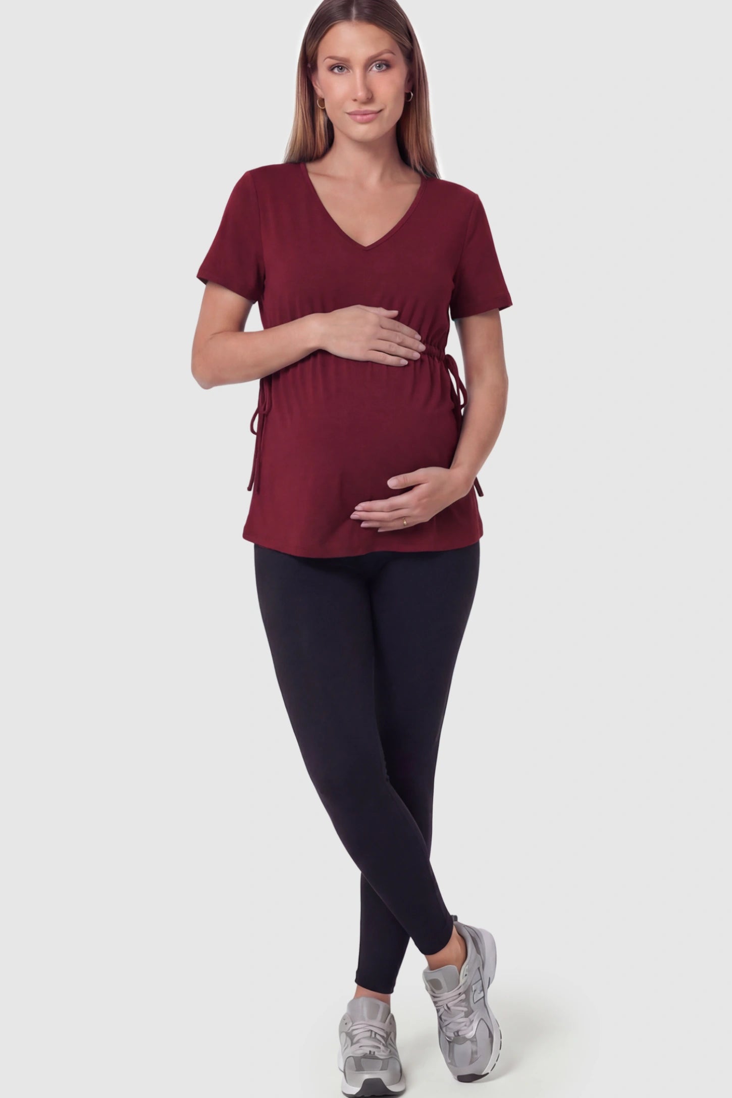 Cinched Waist Short Sleeve Maternity Tunic Top Cinched Waist Short Sleeve Maternity Tunic in Burgundy featuring a stretchy drawstring waist on a pregnant model in full body shot.Cinched Waist Short Sleeve Maternity Tunic in Burgundy featuring a stretchy drawstring waist on a pregnant model in full body shot.
