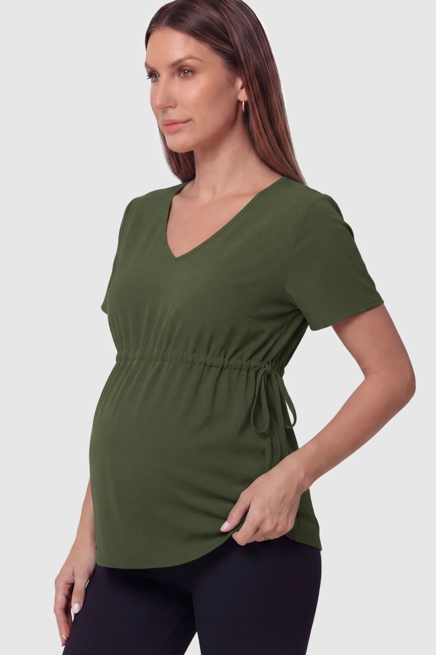 Cinched Waist Short Sleeve Maternity Tunic Top Cinched Waist Short Sleeve Maternity Tunic in Military Green featuring a curved silhouette on a pregnant model in side view.