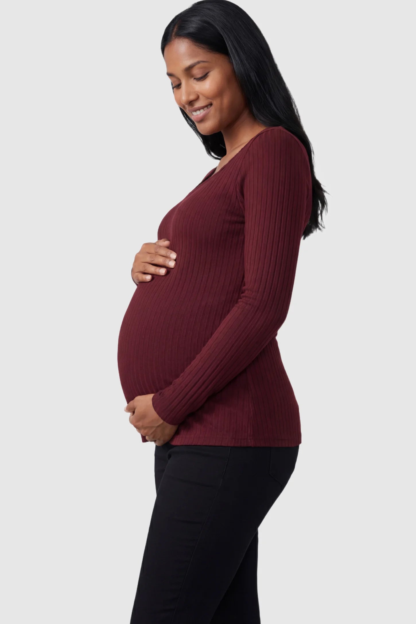 Ribbed Tie-Front Long Sleeve Maternity Top in Burgundy featuring a flexible ribbed knit on a pregnant model.