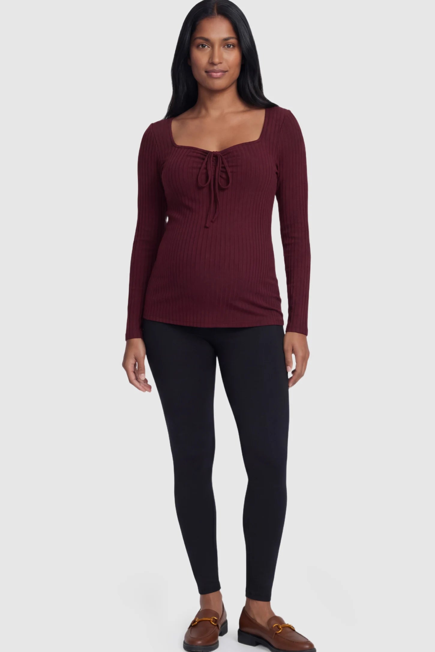 Ribbed Tie-Front Long Sleeve Maternity Top Ribbed Tie-Front Long Sleeve Maternity Top in Burgundy featuring a flexible ribbed knit and adjustable drawstring on a pregnant model.