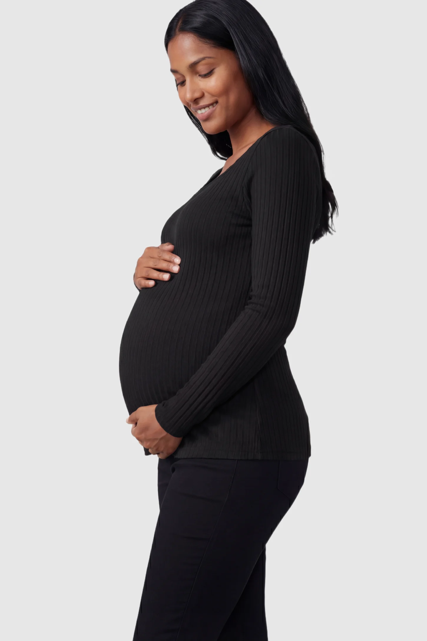 Ribbed Tie-Front Long Sleeve Maternity Top Ribbed Tie-Front Long Sleeve Maternity Top in Black featuring a flexible ribbed knit on a pregnant model.
