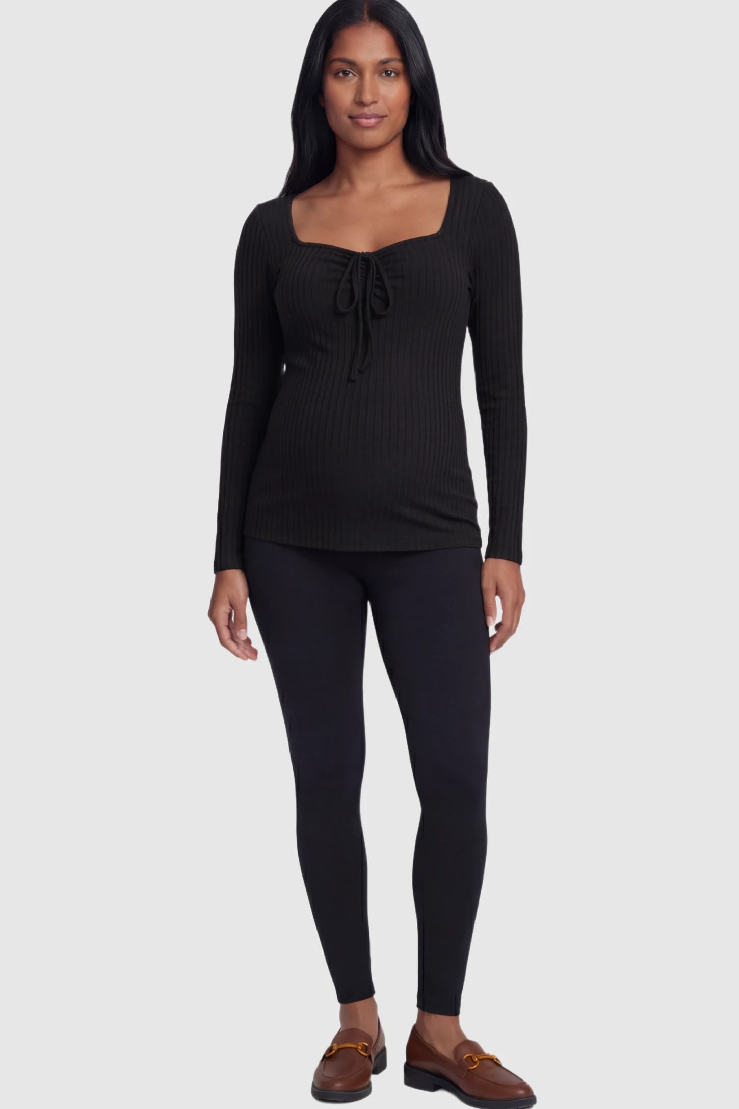 Ribbed Tie-Front Long Sleeve Maternity Top Ribbed Tie-Front Long Sleeve Maternity Top in Black featuring a flexible ribbed knit and adjustable drawstring on a pregnant model.