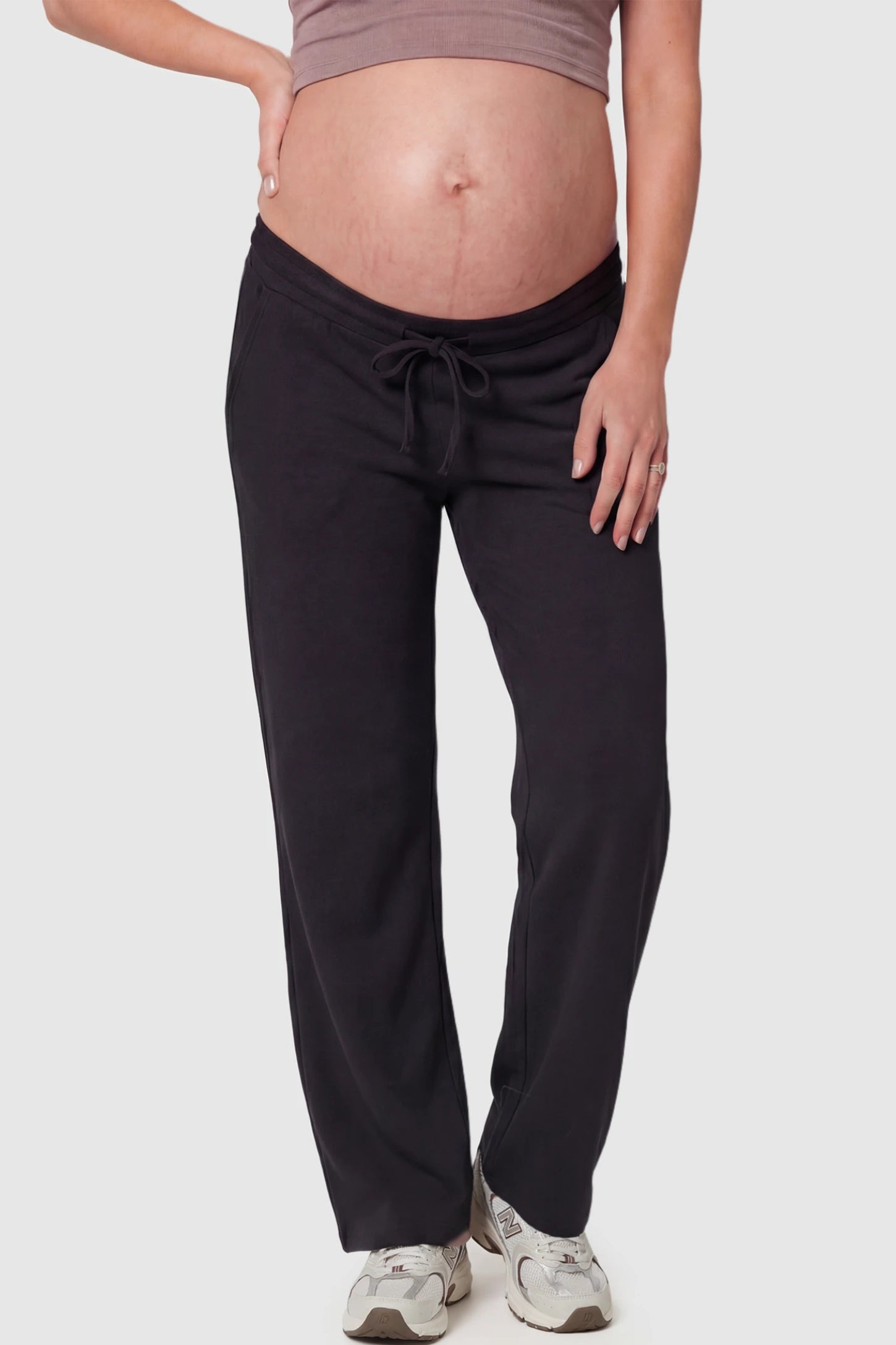 Drawstring Waffle Knit Wide Leg Maternity Lounge Pants Drawstring Waffle Knit Wide Leg Maternity Casual Pants in Black featuring an adjustable waistband on a pregnant model.