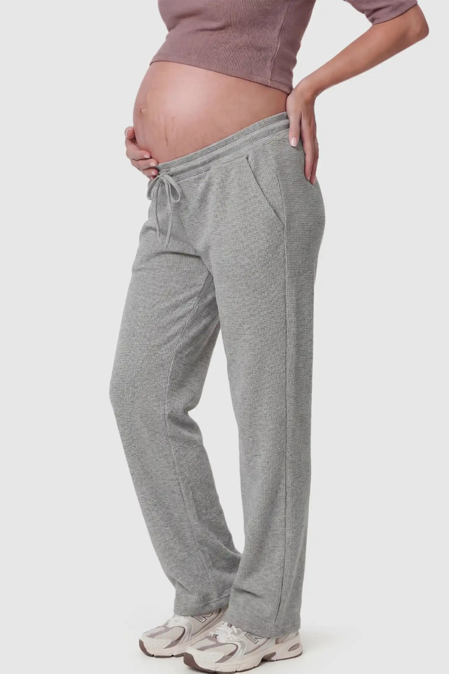 Drawstring Waffle Knit Wide Leg Maternity Lounge Pants Drawstring Waffle Knit Wide Leg Maternity Casual Pants in Gray featuring an adjustable waistband on a pregnant model.