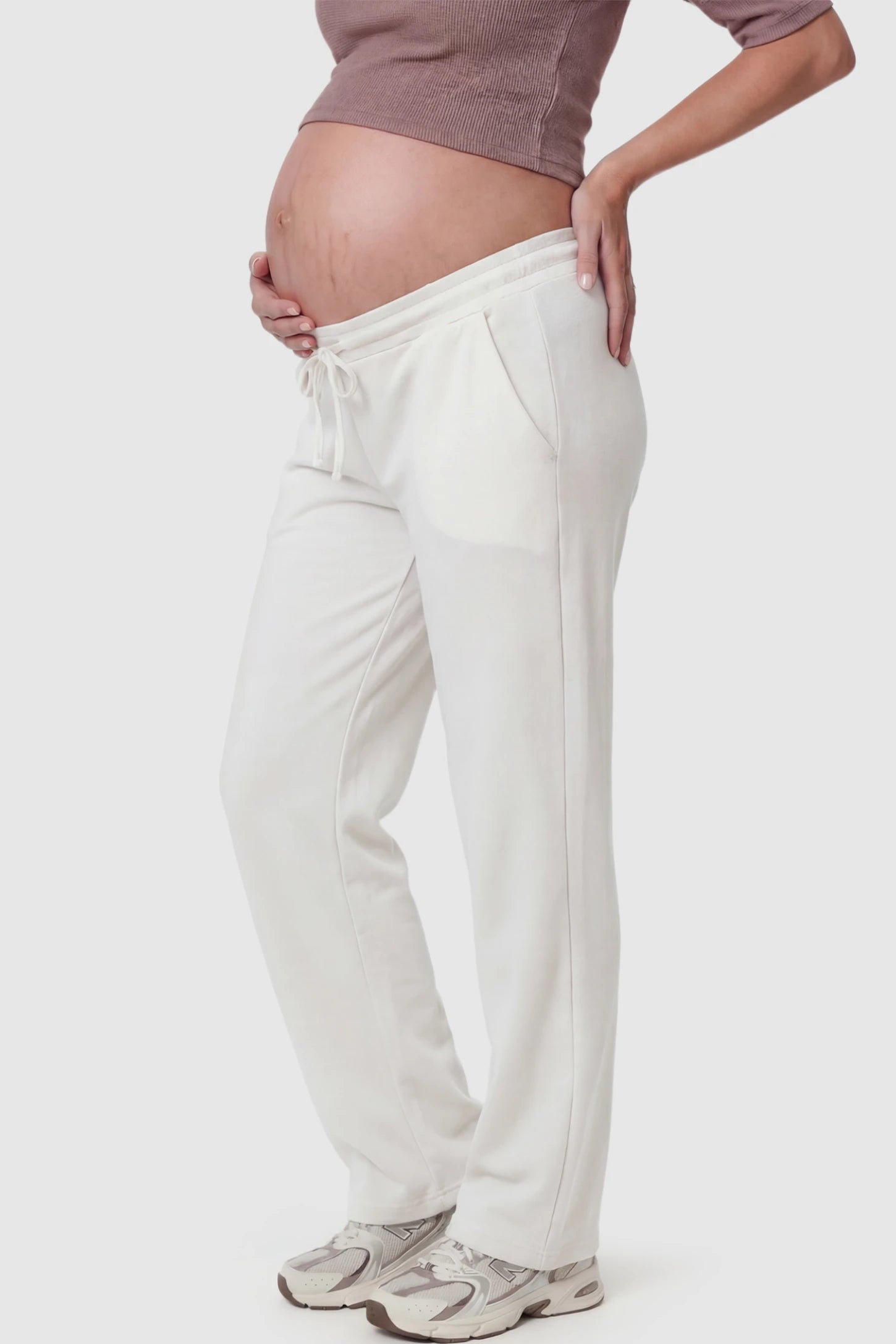 Drawstring Waffle Knit Wide Leg Maternity Lounge Pants Drawstring Waffle Knit Wide Leg Maternity Casual Pants in White featuring an adjustable waistband on a pregnant model.