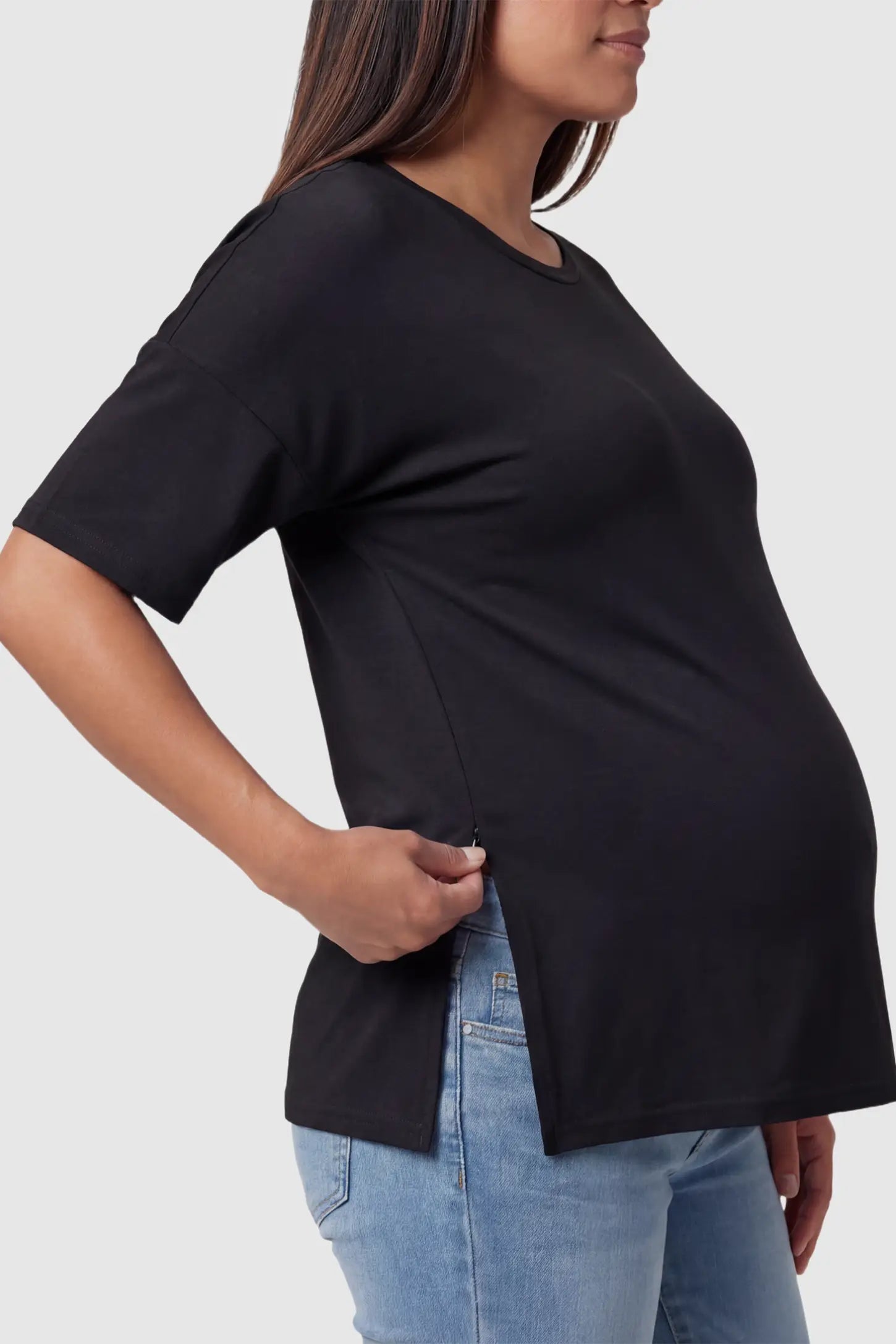 Crew Neck Short Sleeve Maternity T-Shirt Maternity Side-Slit Crew Neck Short Sleeve in Black featuring an oversized wrinkle-resistant fit on a pregnant model.