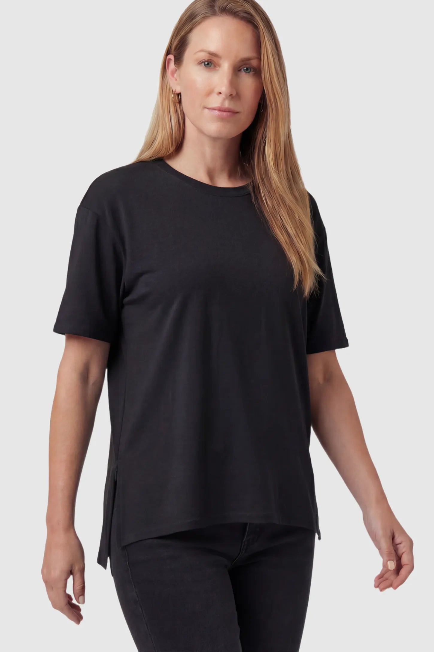 Crew Neck Short Sleeve Maternity T-Shirt Maternity Side-Slit Crew Neck Short Sleeve in Black featuring an oversized wrinkle-resistant fit on a non pregnant model.