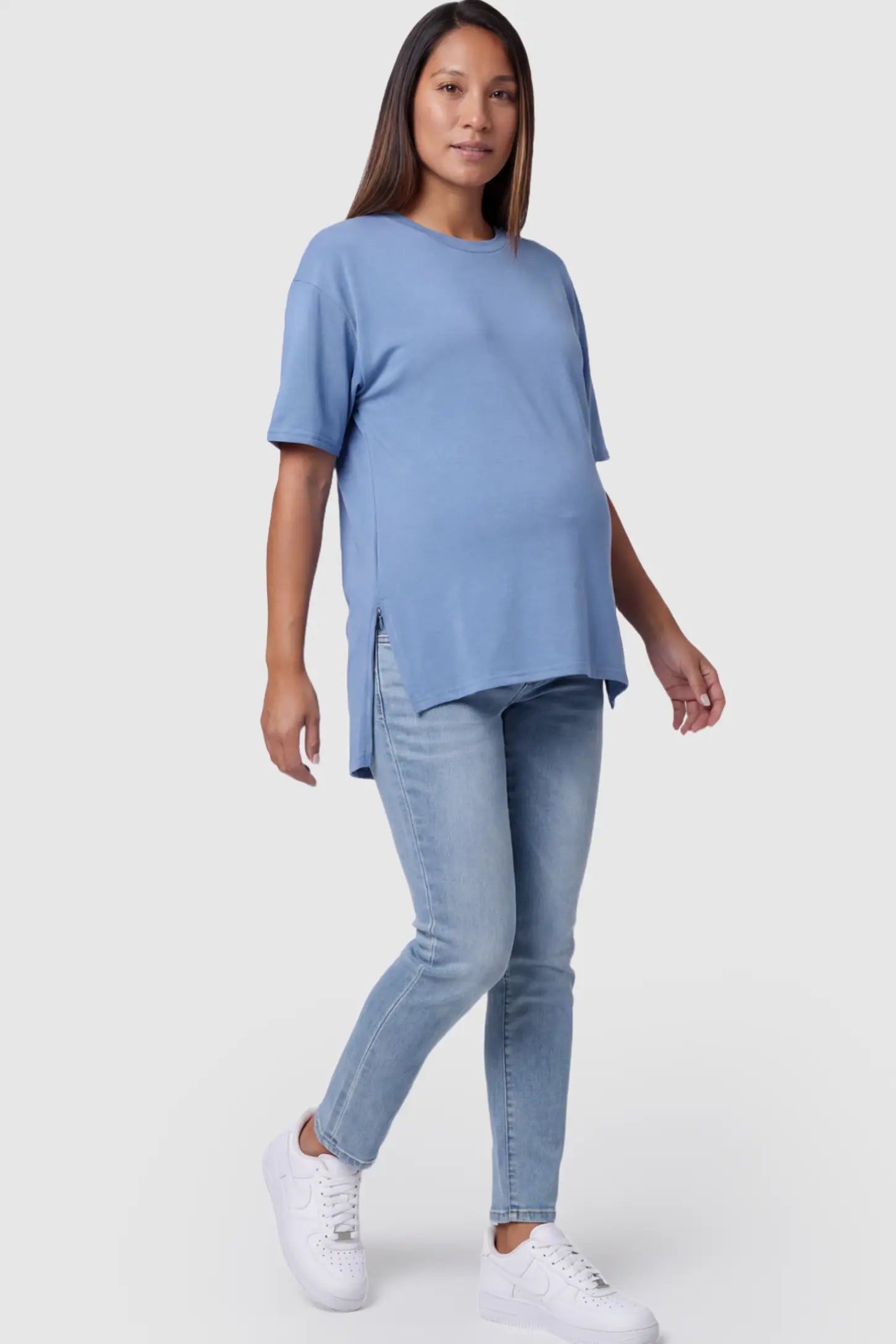 Crew Neck Short Sleeve Maternity T-Shirt Maternity Side-Slit Crew Neck Short Sleeve in Blue featuring an oversized wrinkle-resistant fit on a pregnant model.