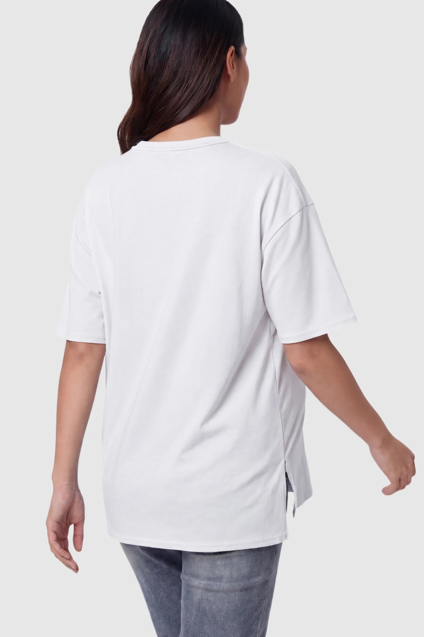 Crew Neck Short Sleeve Maternity T-Shirt Maternity Side-Slit Crew Neck Short Sleeve in White featuring an oversized wrinkle-resistant fit on a pregnant model.