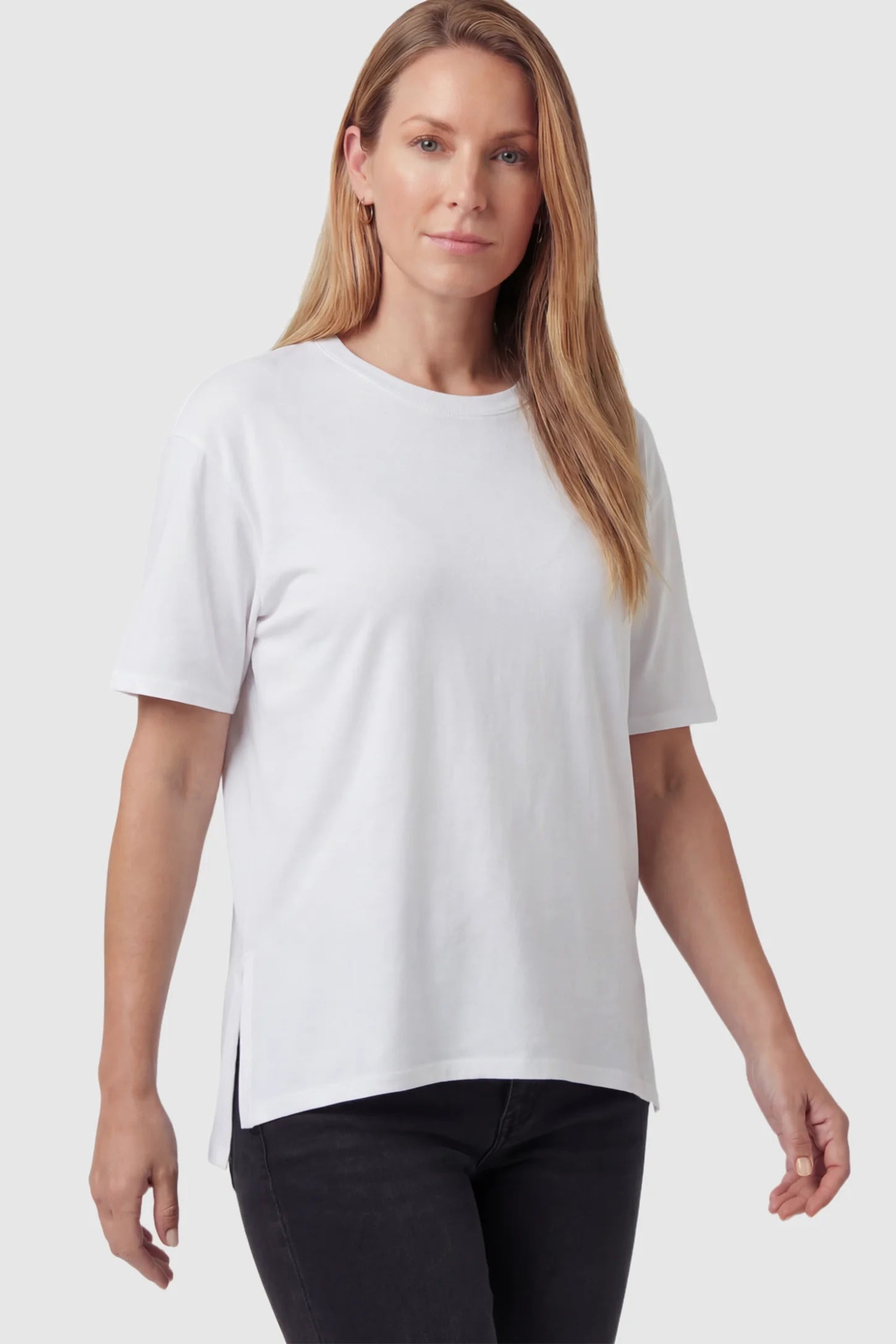 Crew Neck Short Sleeve Maternity T-Shirt Maternity Side-Slit Crew Neck Short Sleeve in White featuring an oversized wrinkle-resistant fit on a non pregnant model.