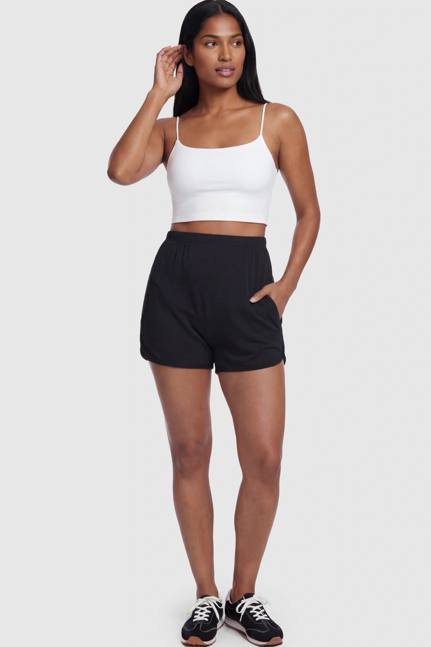 Full Panel Dolphin Hem Maternity Lounge Shorts Full Panel Maternity Lounge Shorts in Black featuring a dolphin hem on a postpartum model.