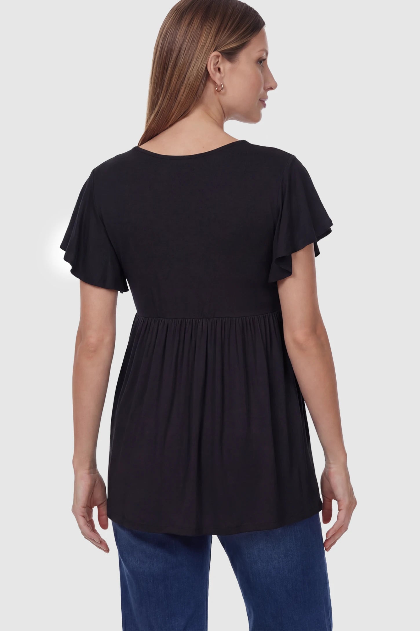 Solid Ruffled-Sleeve Flowy Maternity Top Solid Ruffled-Sleeve Flowy Maternity Top in Black featuring a pleated empire waist on a pregnant model in back view.