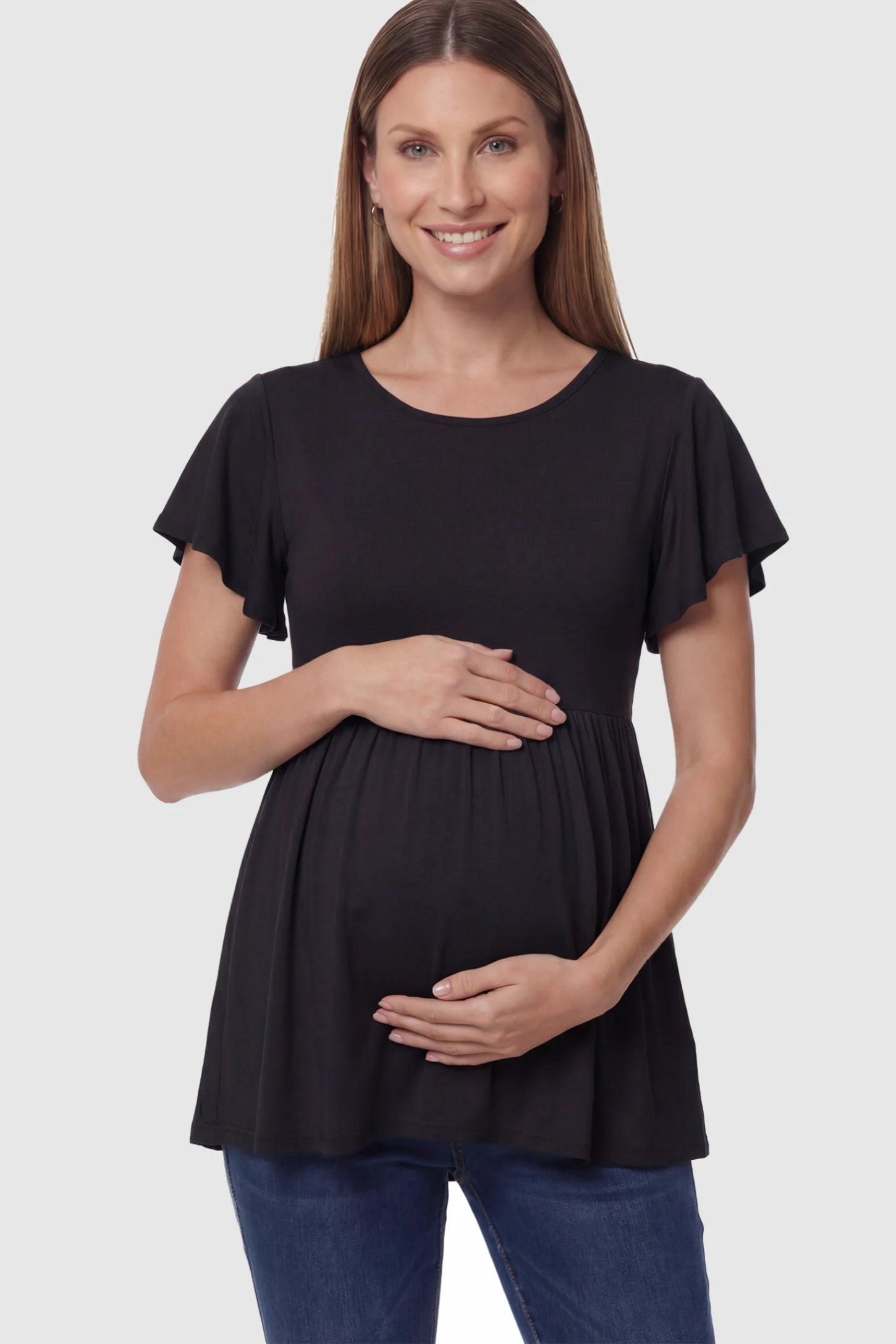 Solid Ruffled-Sleeve Flowy Maternity Top Solid Ruffled-Sleeve Flowy Maternity Top in Black featuring a pleated empire waist on a pregnant model in front view.