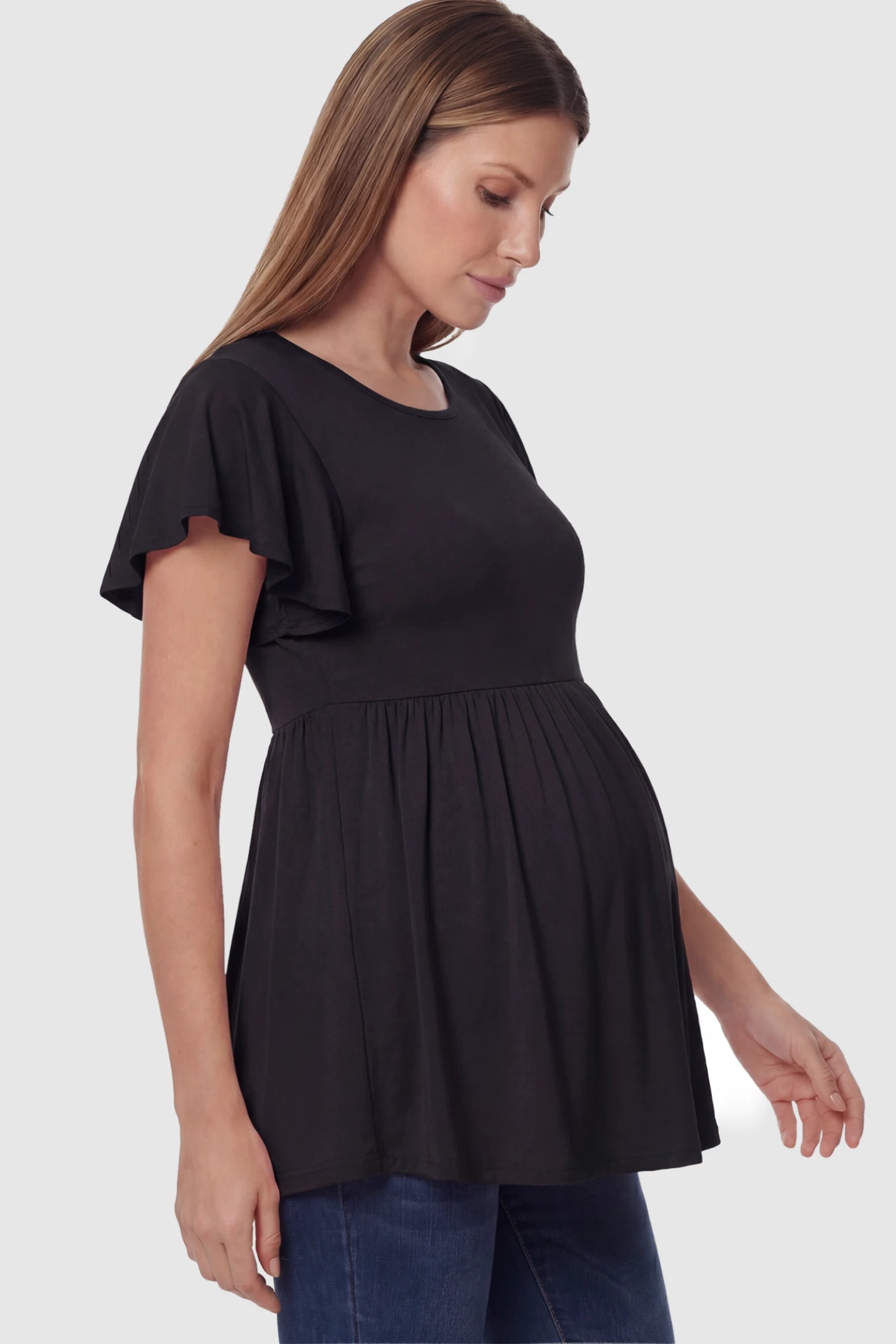 Solid Ruffled-Sleeve Flowy Maternity Top Solid Ruffled-Sleeve Flowy Maternity Top in Black featuring a pleated empire waist on a pregnant model in side view.
