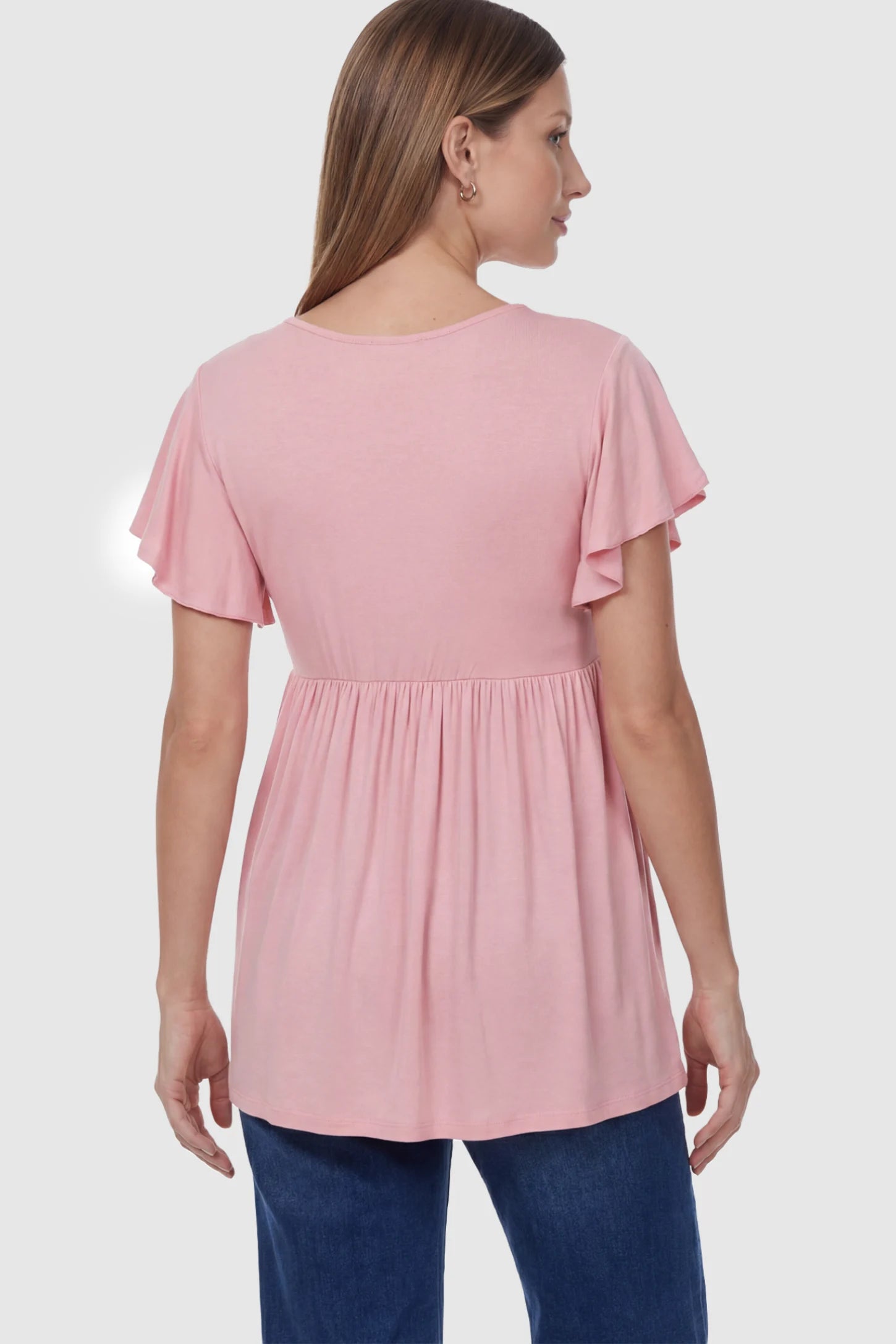 Solid Ruffled-Sleeve Flowy Maternity Top Solid Ruffled-Sleeve Flowy Maternity Top in Pink featuring a pleated empire waist on a pregnant model in back view.