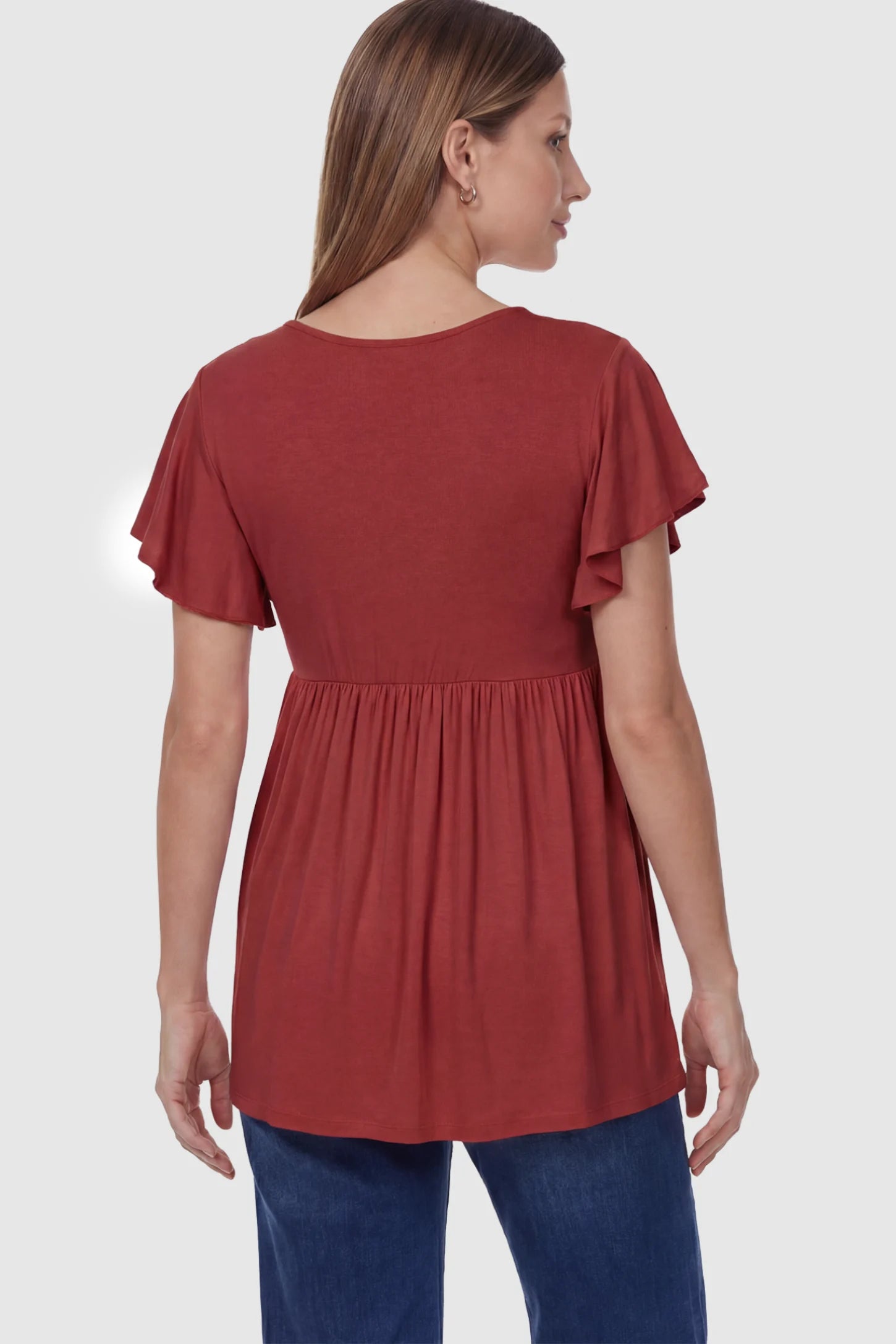 Solid Ruffled-Sleeve Flowy Maternity Top Solid Ruffled-Sleeve Flowy Maternity Top in Red featuring a pleated empire waist on a pregnant model in back view.