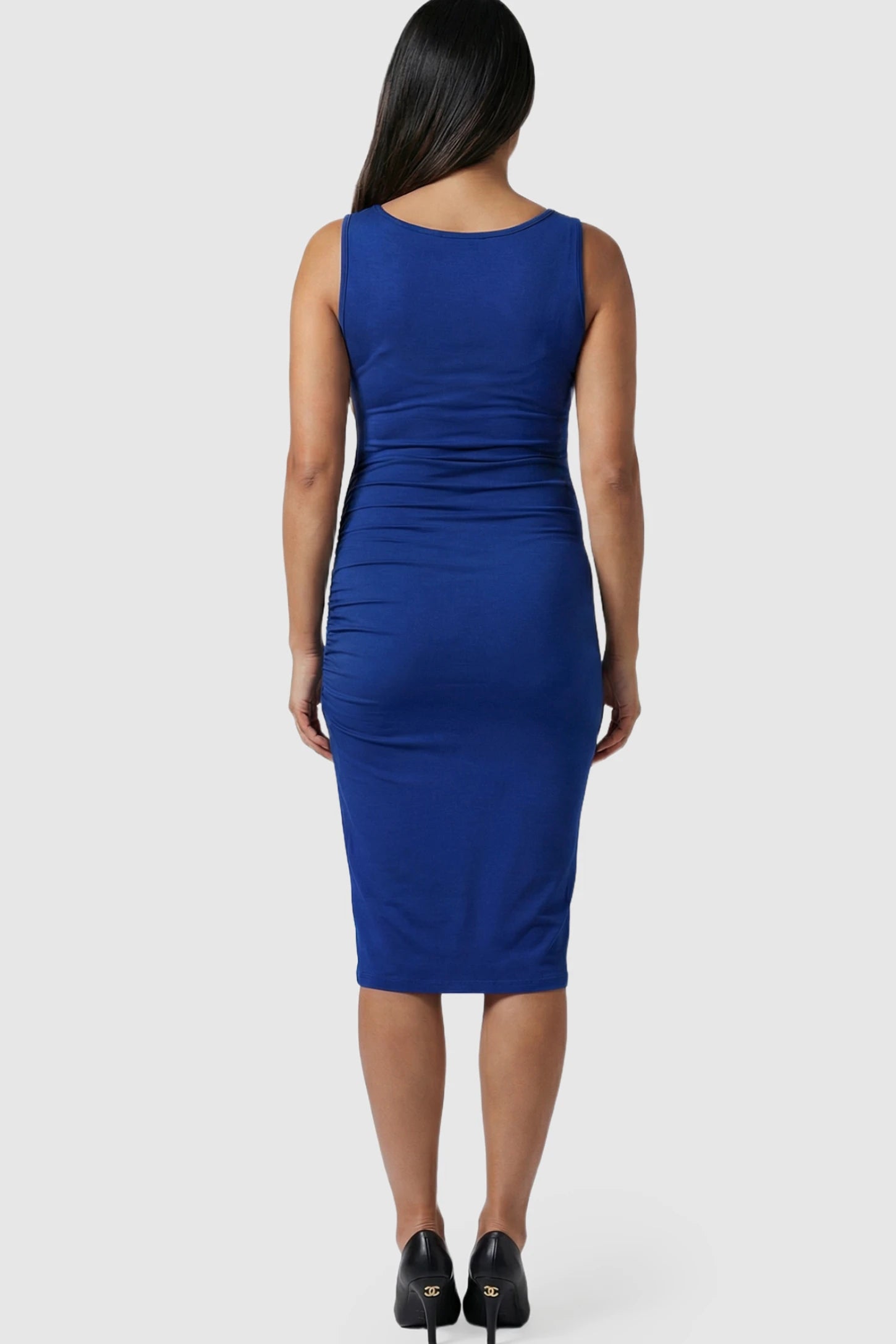 Ruched Tulip-Hem Sleeveless Bodycon Maternity Dress Ruched Tulip-Hem Bodycon Maternity Dress in Navy Blue featuring a pencil skirt on a pregnant model.