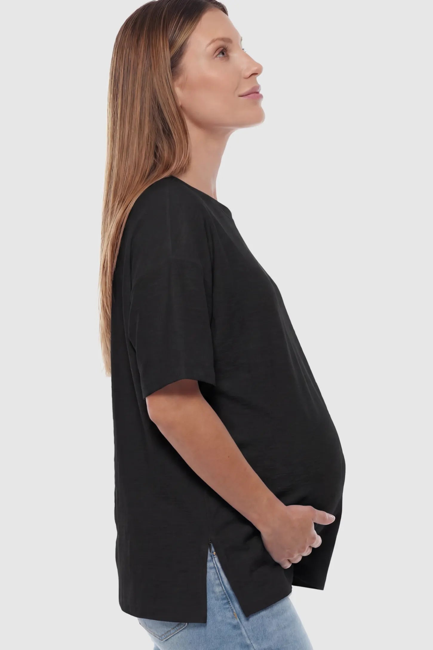 Textured Oversized Short Sleeve Maternity T-Shirt in Black featuring a side-slit hem and drop shoulders on a model.