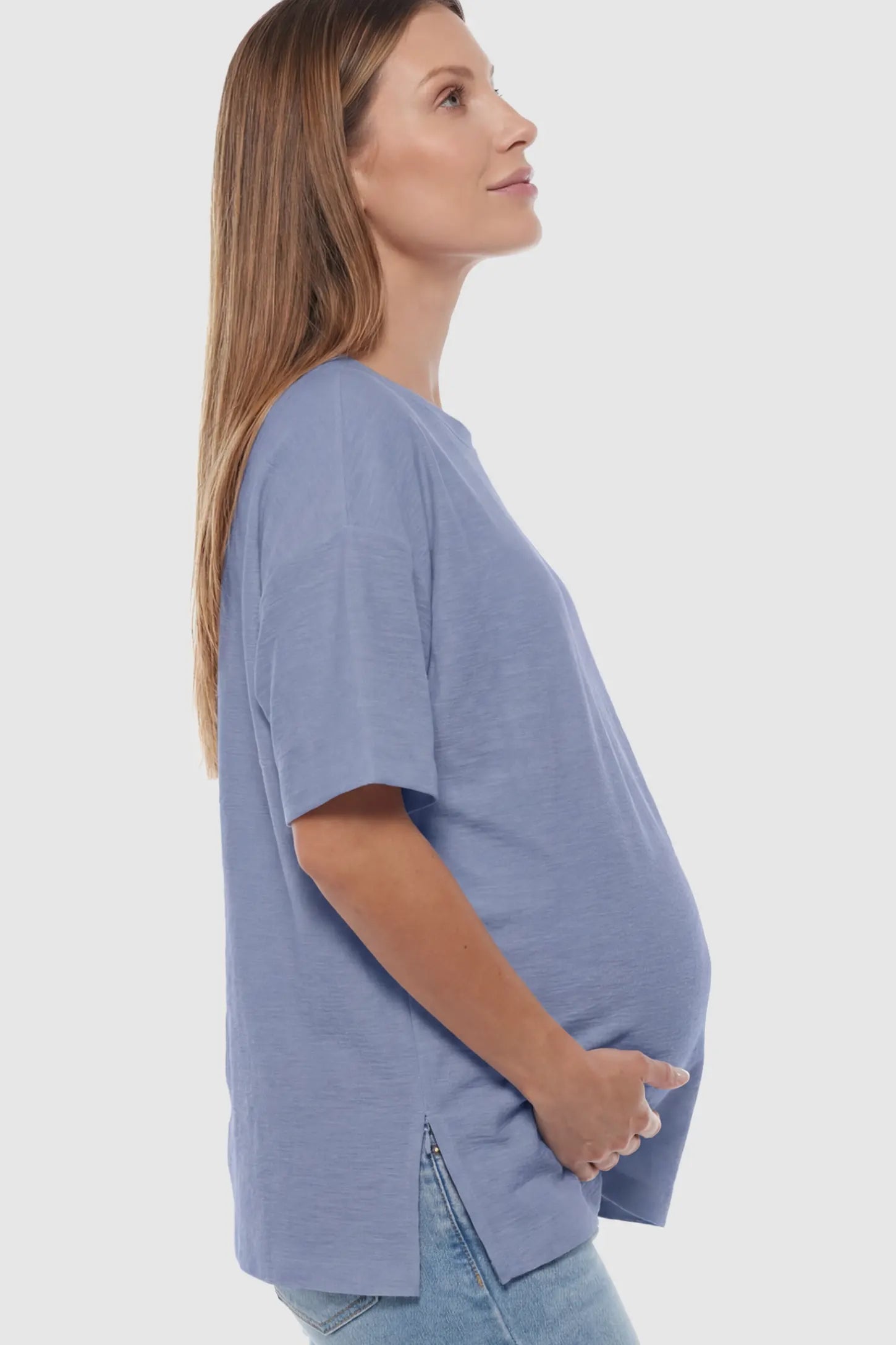 Oversized Short Sleeve Maternity T-Shirt Textured Oversized Short Sleeve Maternity T-Shirt in Light Blue featuring a side-slit hem and drop shoulders on a model.