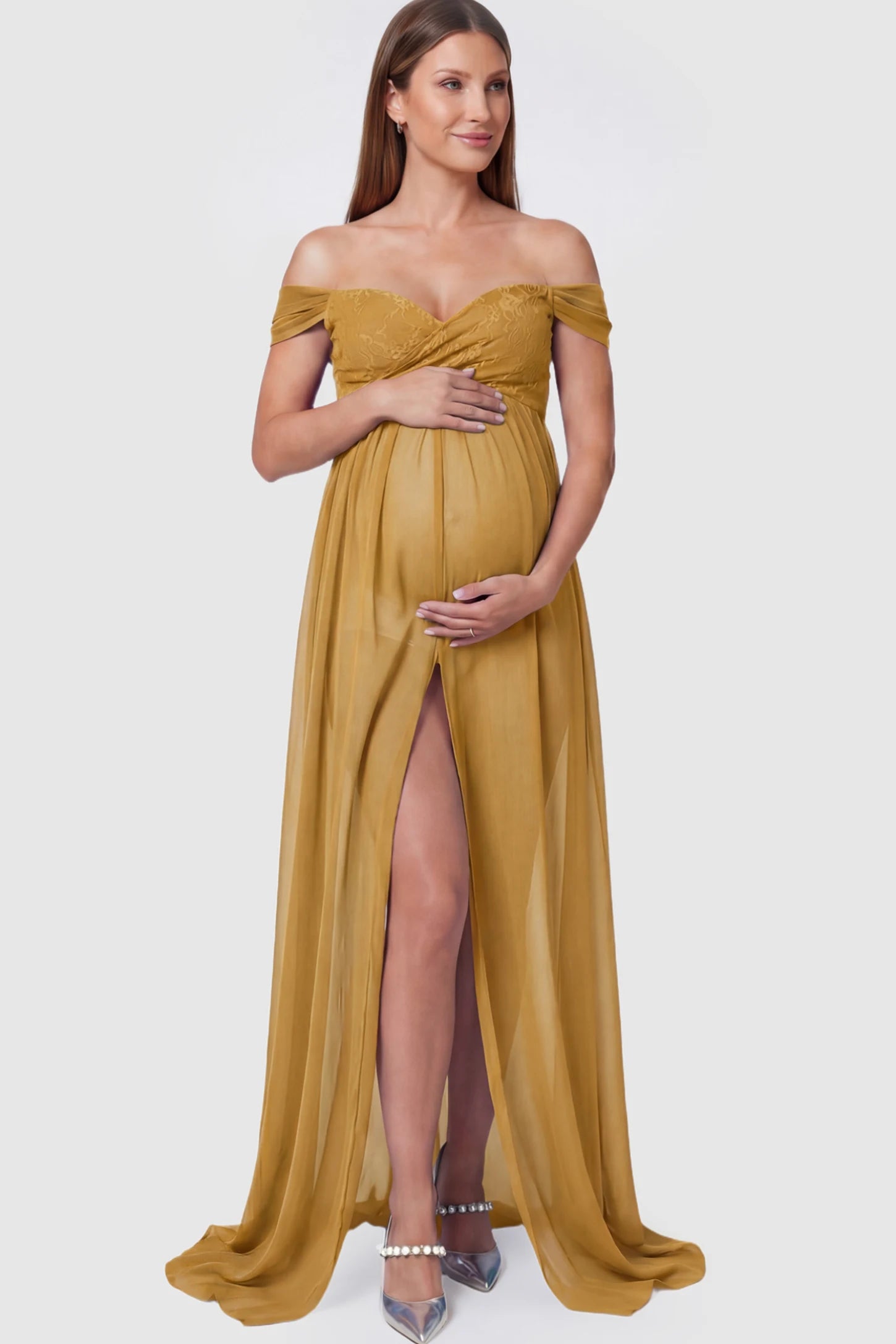 Lace Off Shoulder Slit Front Maternity Photoshoot Gown Lace Off Shoulder Slit Front Maternity Photoshoot Gown in apricot yellow featuring a flowy chiffon opening on a pregnant model.