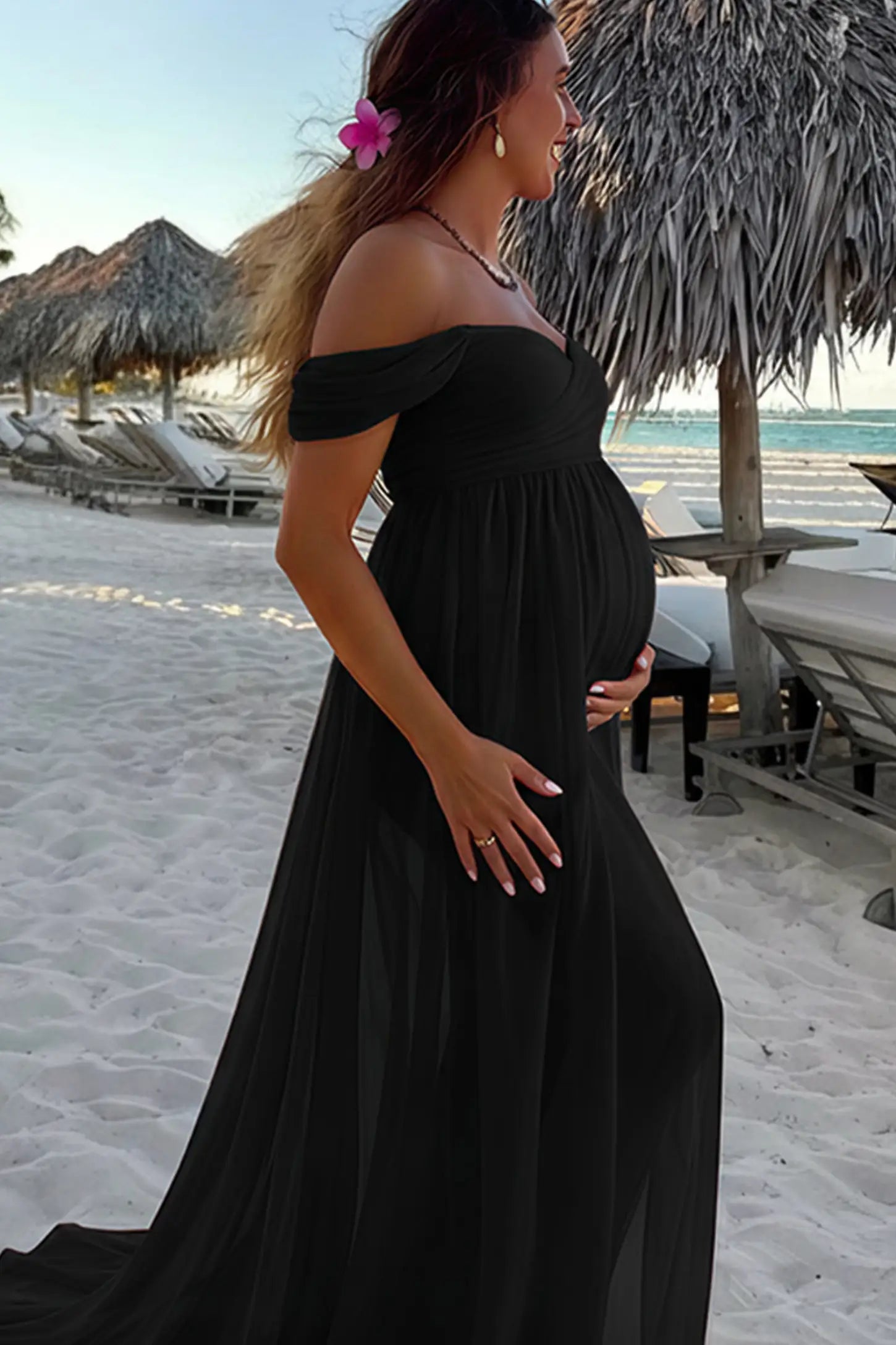 Lace Off Shoulder Slit Front Maternity Photoshoot Gown Lace Off Shoulder Slit Front Maternity Photoshoot Gown in black featuring a flowy chiffon opening on a pregnant model.