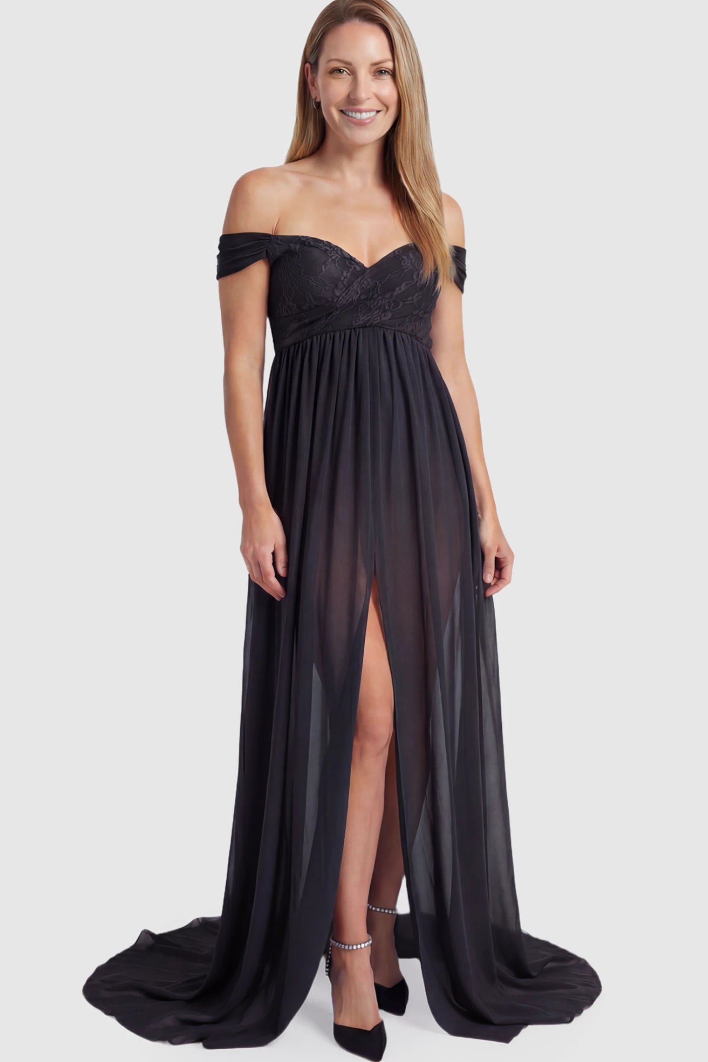Lace Off Shoulder Slit Front Maternity Photoshoot Gown Lace Off Shoulder Slit Front Maternity Photoshoot Gown in black featuring a flowy chiffon opening on a postpartum model.