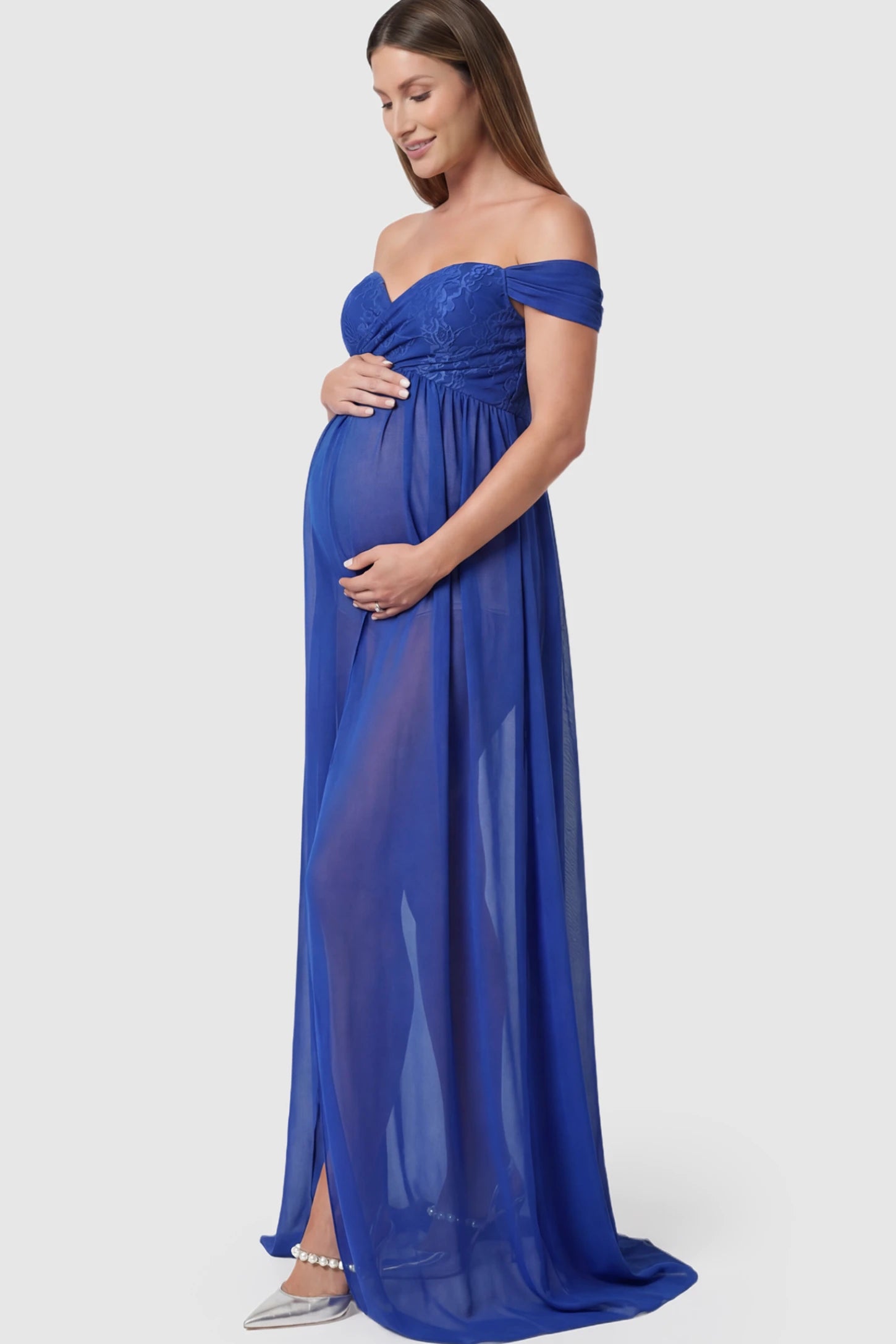 Lace Off Shoulder Slit Front Maternity Photoshoot Gown Lace Off Shoulder Slit Front Maternity Photoshoot Gown in blue featuring a flowy chiffon opening on a pregnant model.