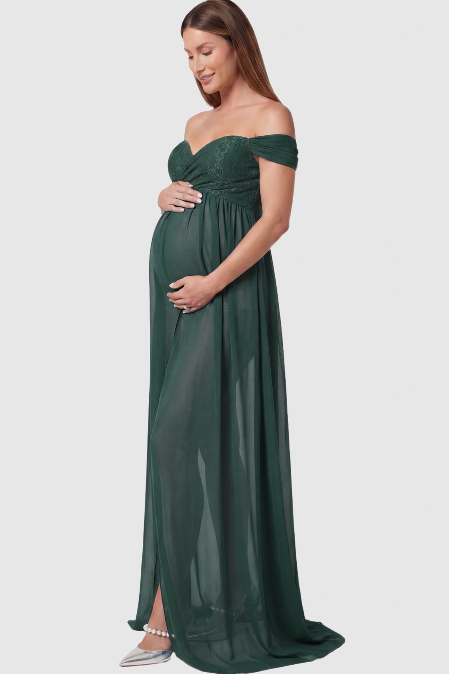 Lace Off Shoulder Slit Front Maternity Photoshoot Gown Lace Off Shoulder Slit Front Maternity Photoshoot Gown in dark green featuring a flowy chiffon opening on a pregnant model.