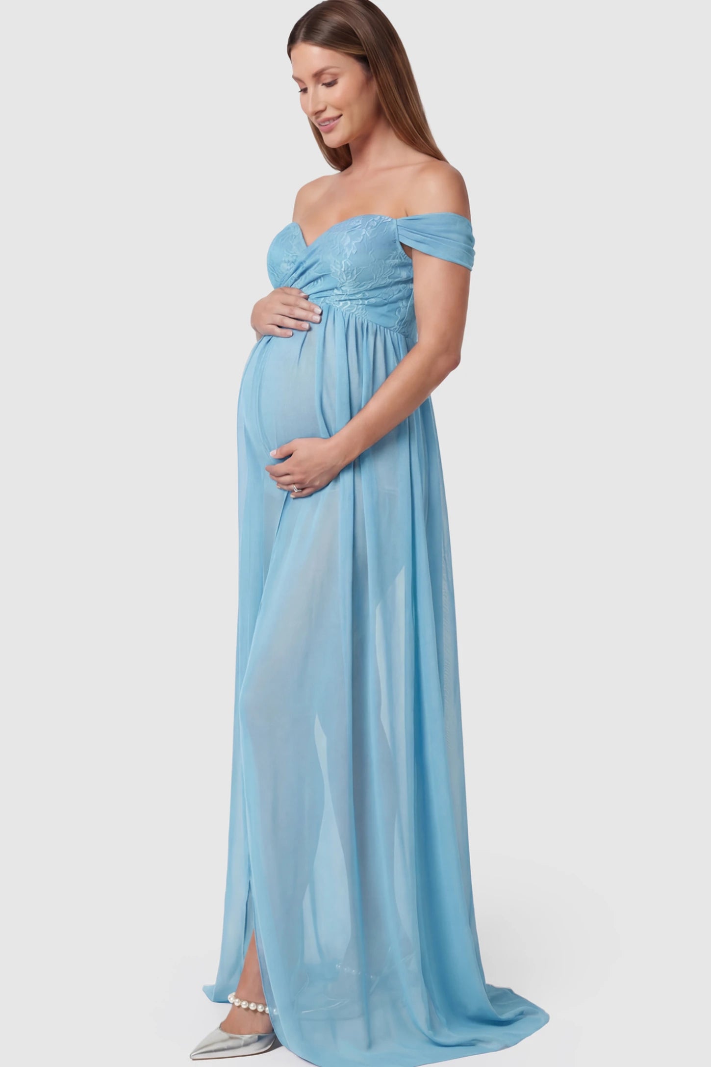 Lace Off Shoulder Slit Front Maternity Photoshoot Gown Lace Off Shoulder Slit Front Maternity Photoshoot Gown in light blue featuring a flowy chiffon opening on a pregnant model.