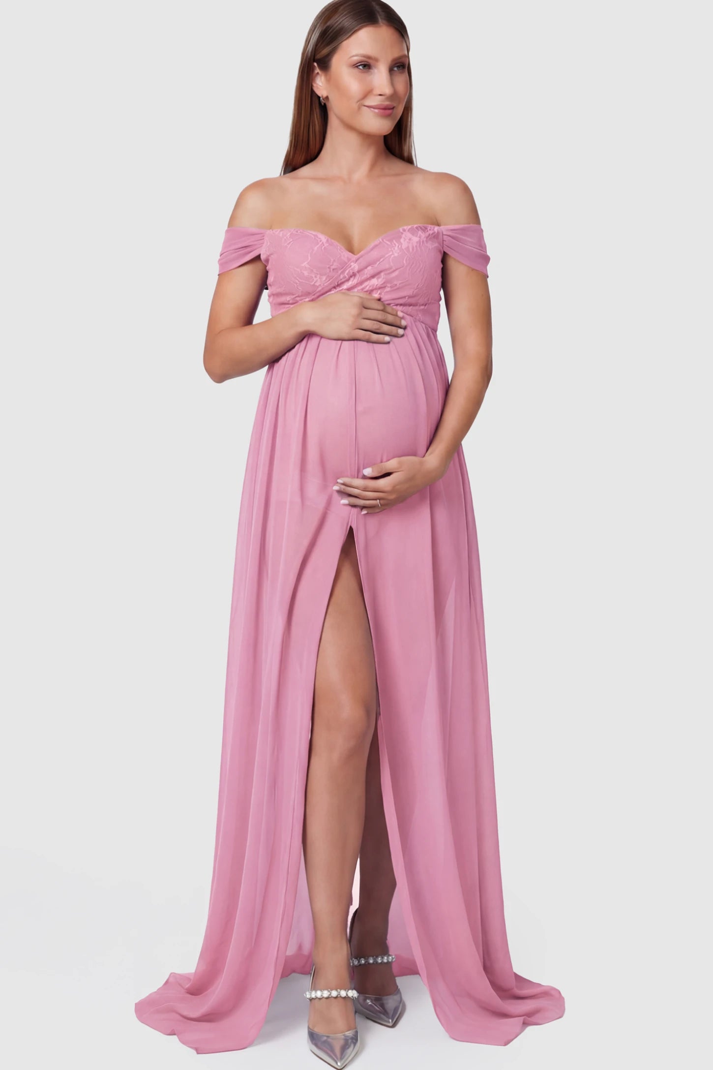 Lace Off Shoulder Slit Front Maternity Photoshoot Gown in Pink featuring a flowy chiffon opening on a pregnant model.