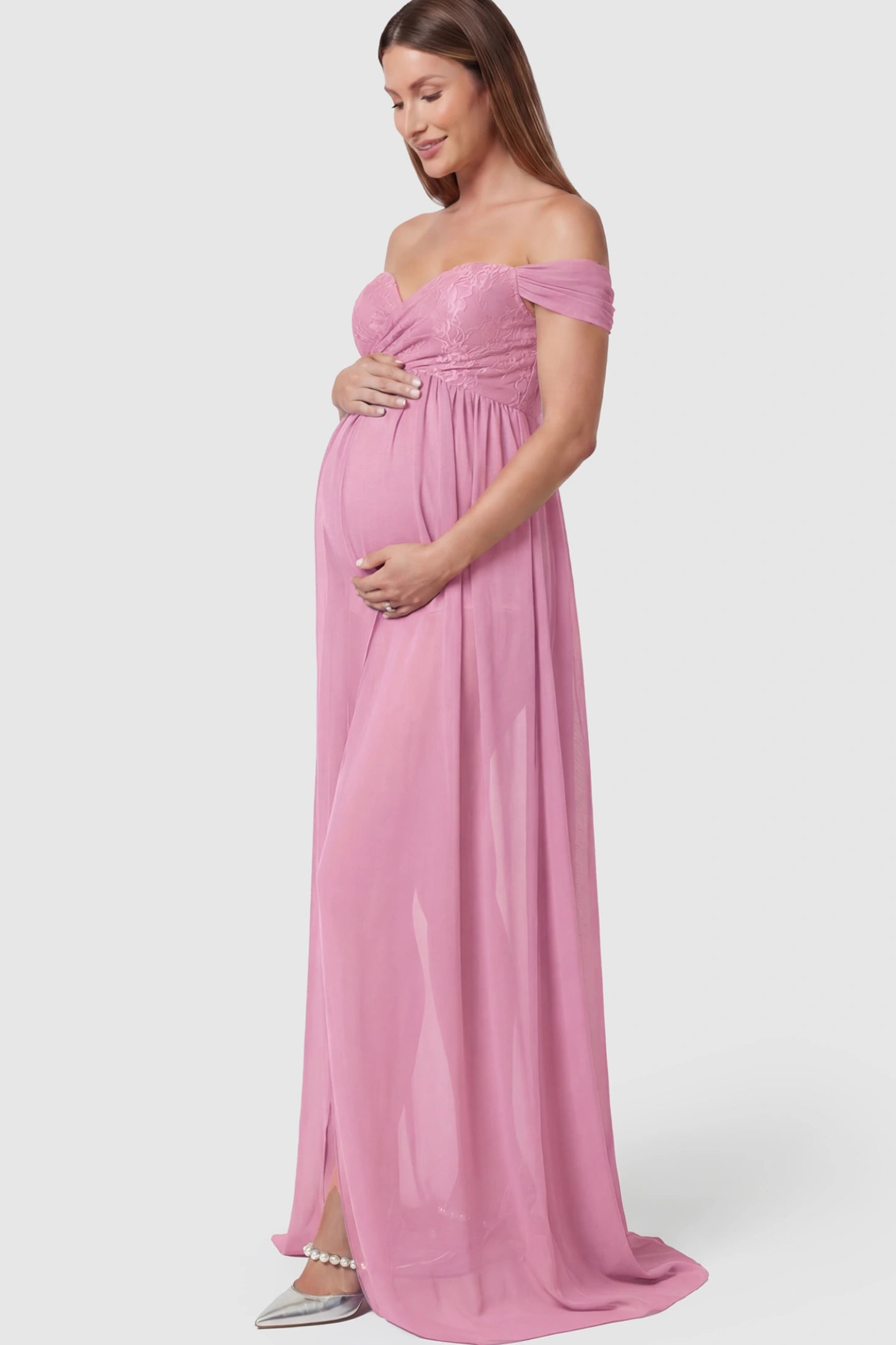 Lace Off Shoulder Slit Front Maternity Photoshoot Gown in Pink featuring a flowy chiffon opening on a pregnant model.
