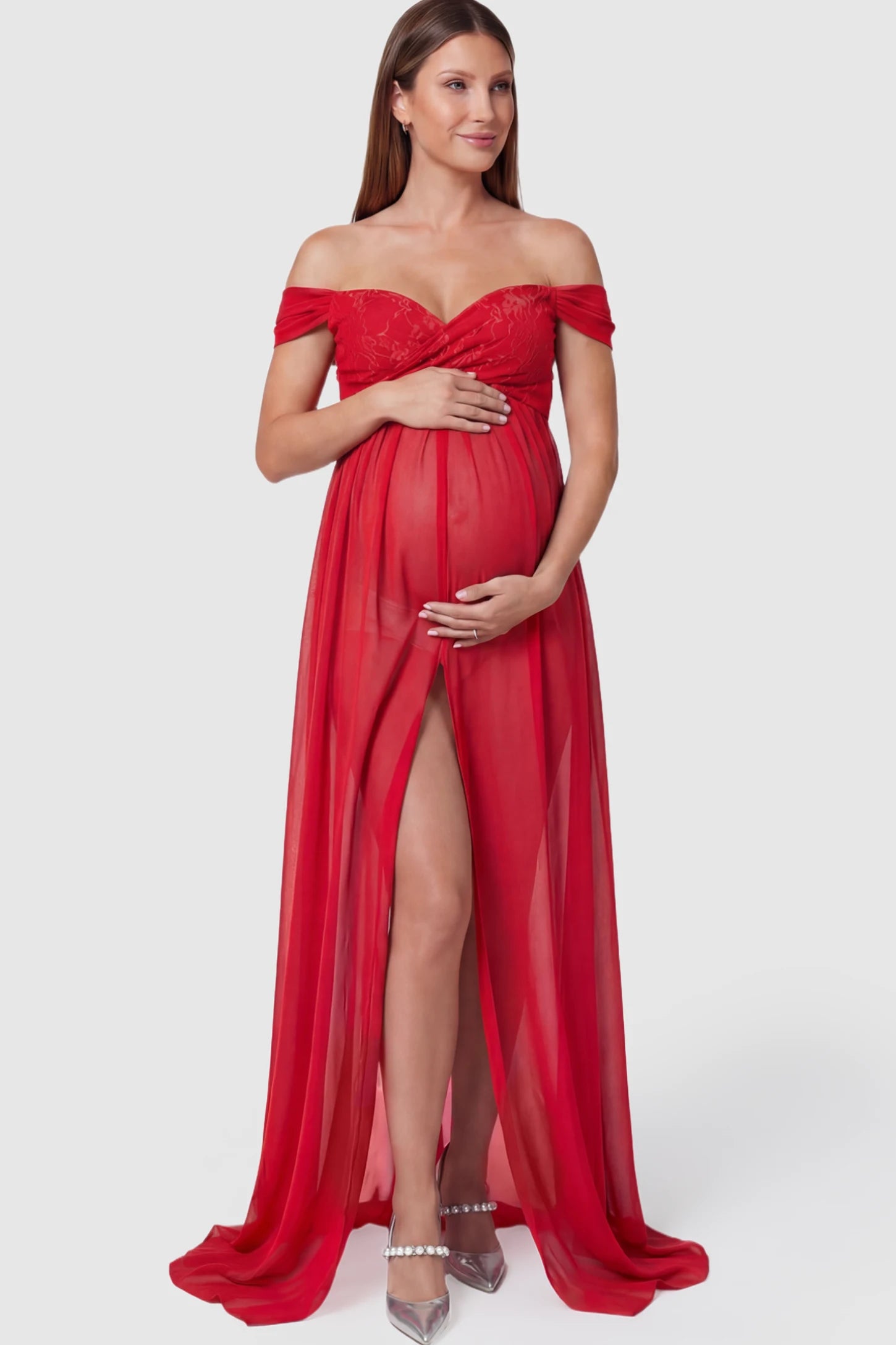 Lace Off Shoulder Slit Front Maternity Photoshoot Gown Lace Off Shoulder Slit Front Maternity Photoshoot Gown in red featuring a flowy chiffon opening on a pregnant model.