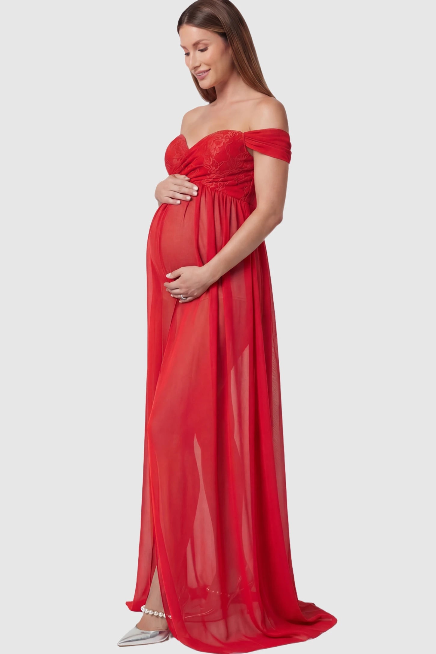 Lace Off Shoulder Slit Front Maternity Photoshoot Gown Lace Off Shoulder Slit Front Maternity Photoshoot Gown in red featuring a flowy chiffon opening on a pregnant model.