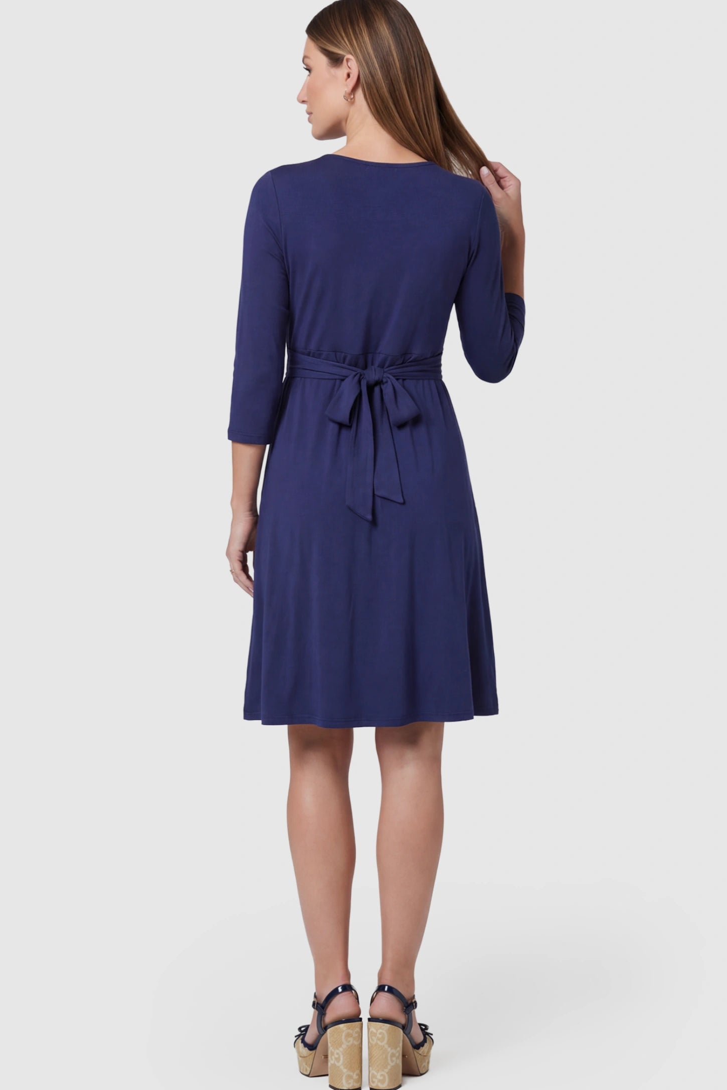 Layered Wrap Front Maternity Nursing Dress Layered Wrap Front Maternity Nursing Dress in Dark Blue on a pregnant model.