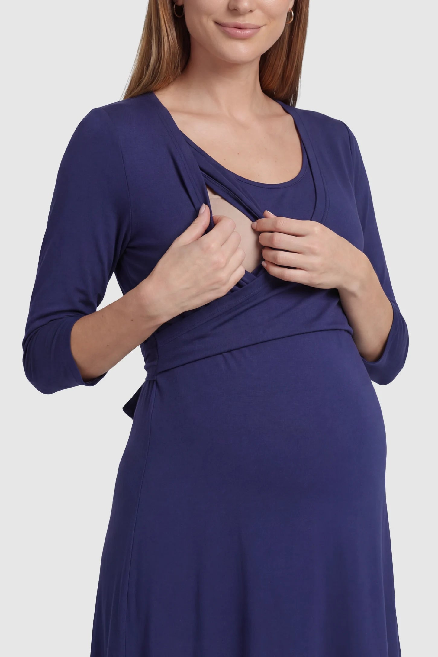 Layered Wrap Front Maternity Nursing Dress Layered Wrap Front Maternity Nursing Dress in Dark Blue featuring a double-layer nursing opening on a pregnant model.